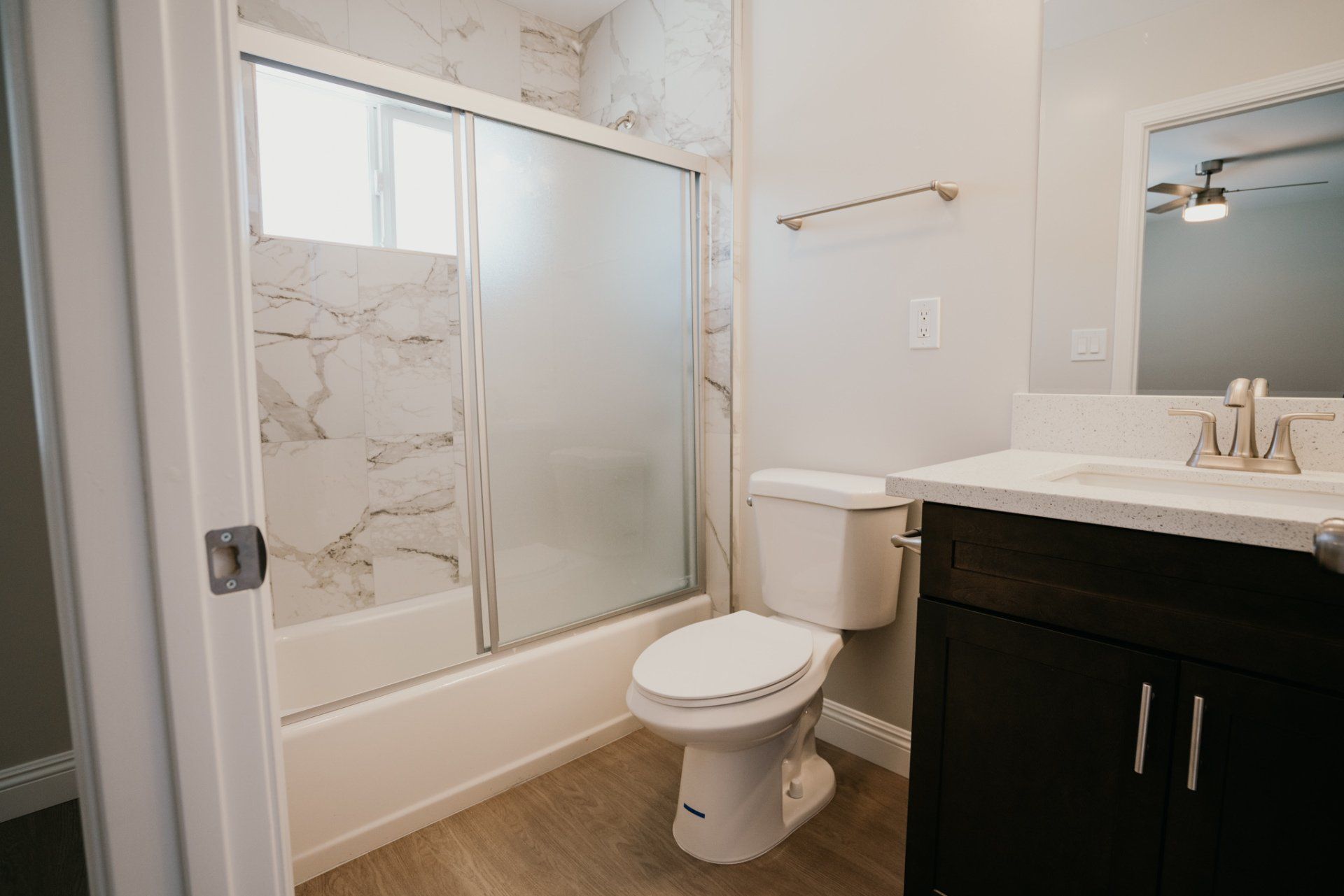 A bathroom with a toilet , sink , and shower.