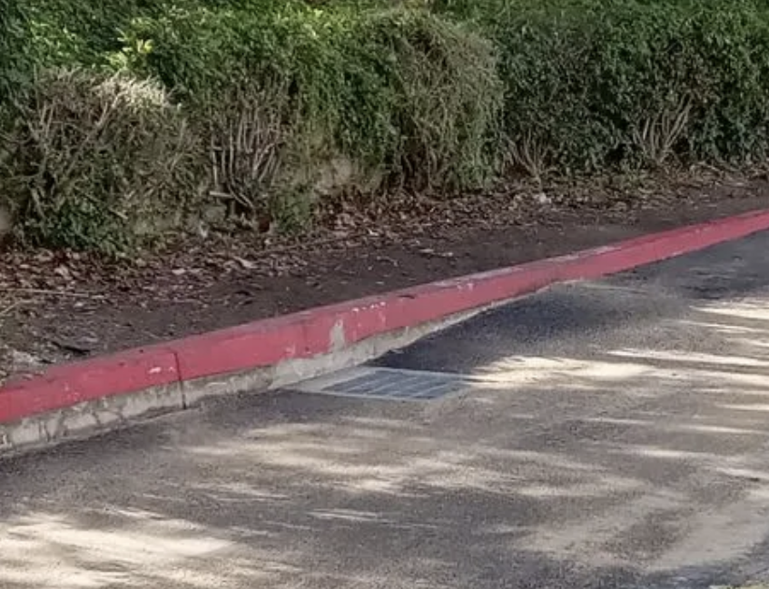 There is a red curb on the side of the road.