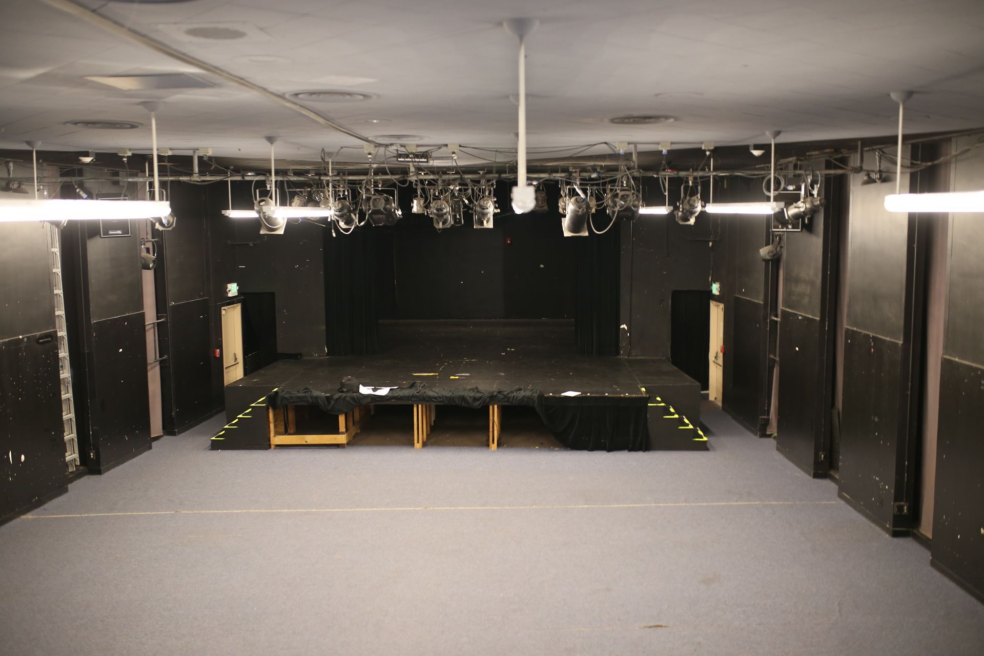 A large empty room with a stage in the middle