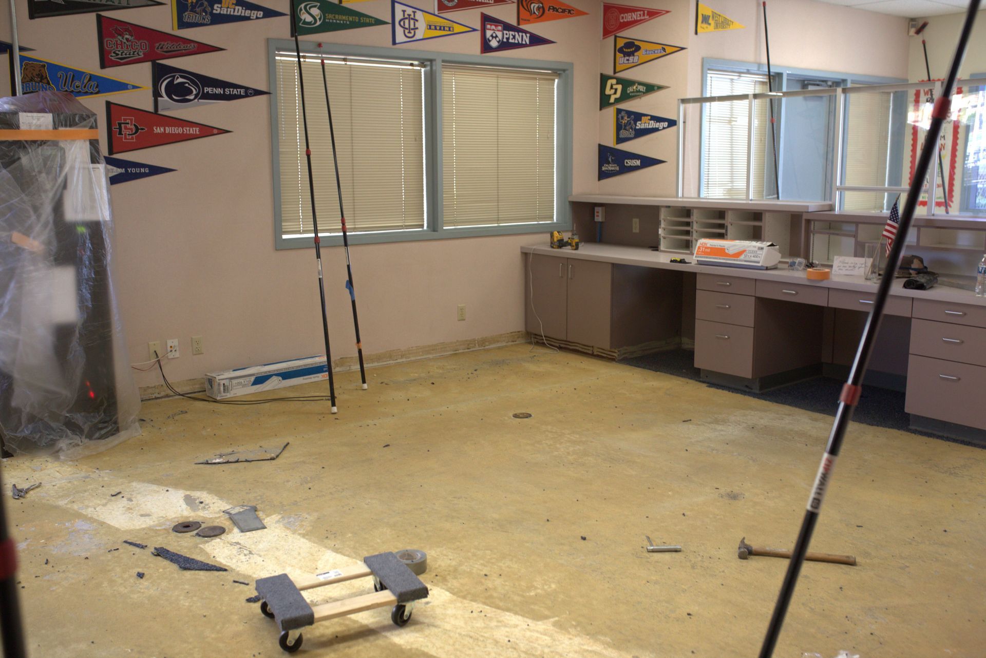 An empty room with a bunch of flags on the wall