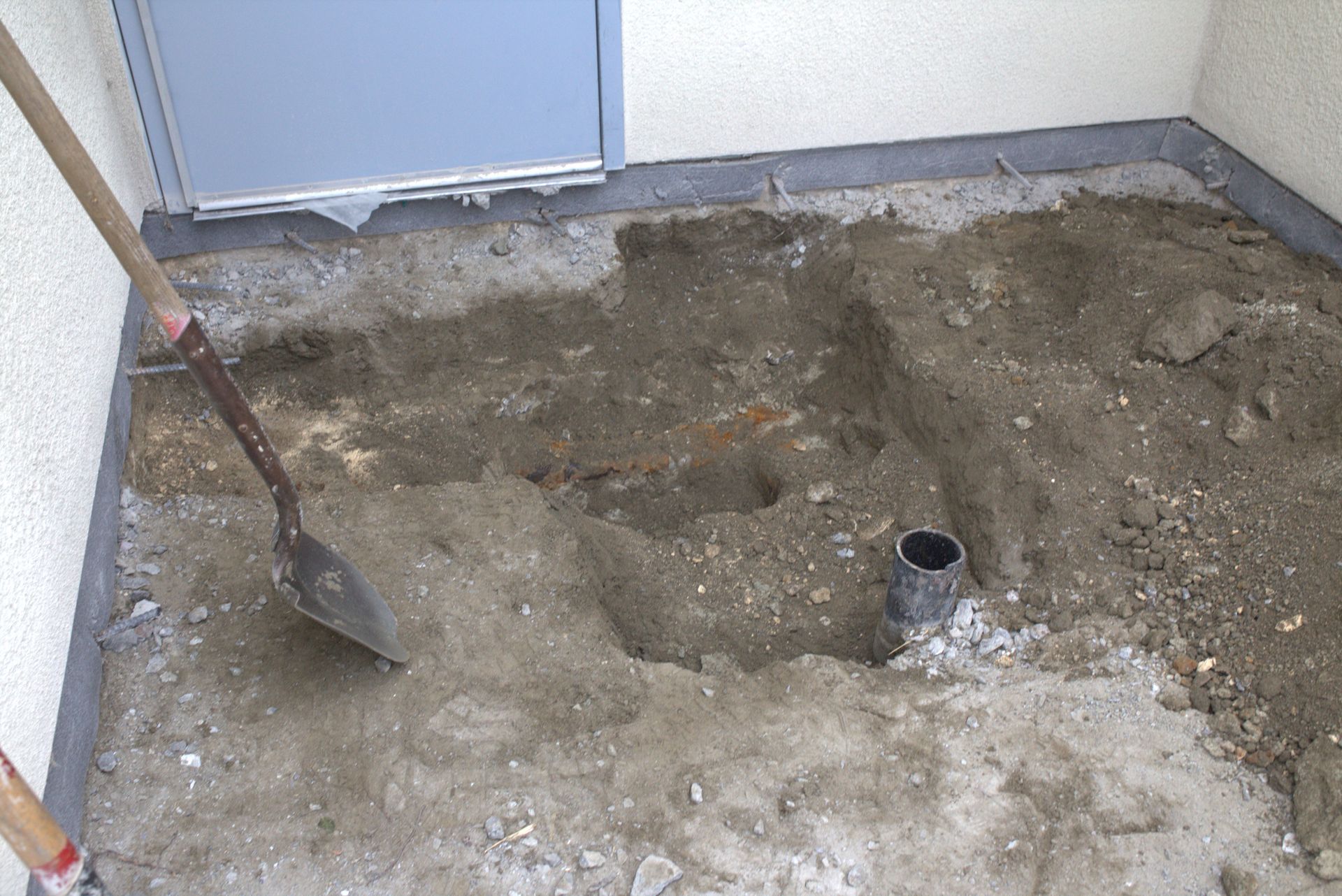 A person is digging a hole in the ground with a shovel.
