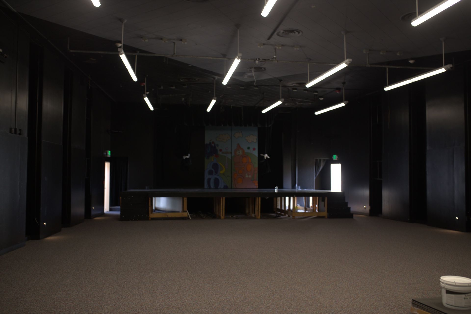 A large empty room with a stage in the middle