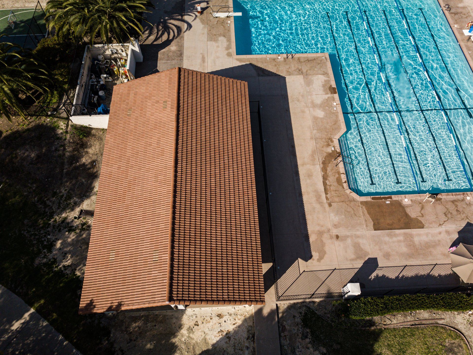 An aerial view of a building next to a swimming pool