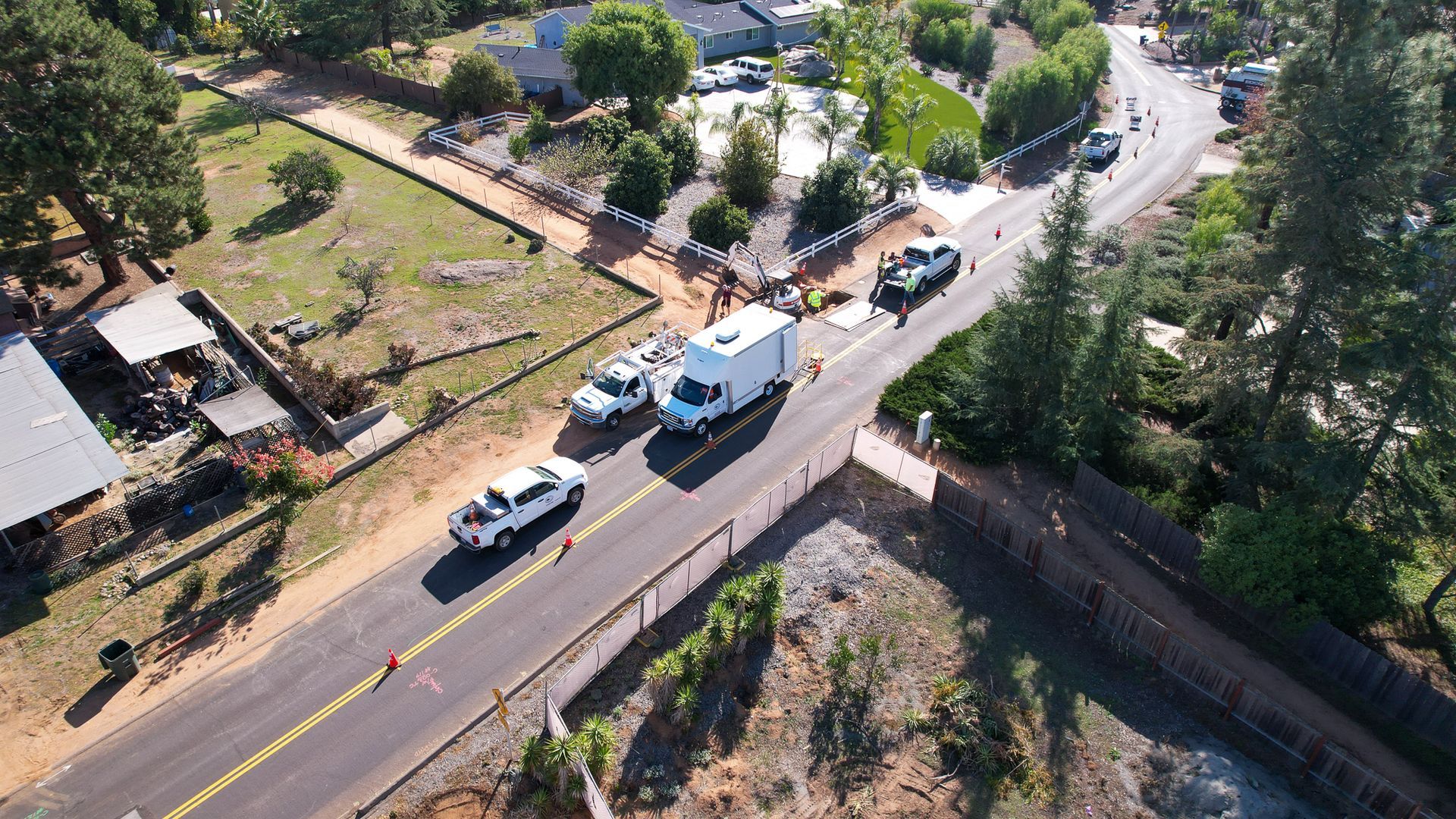 An aerial view of a road with cars driving down it