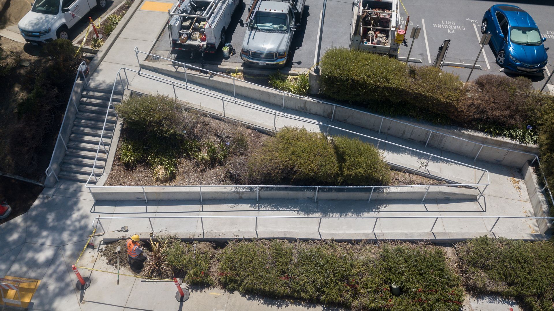An aerial view of a parking lot with cars parked in it