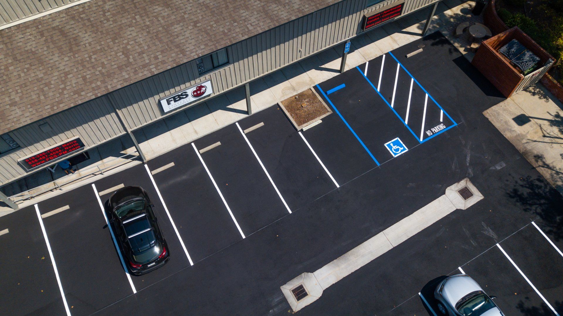 An aerial view of a parking lot in front of a store