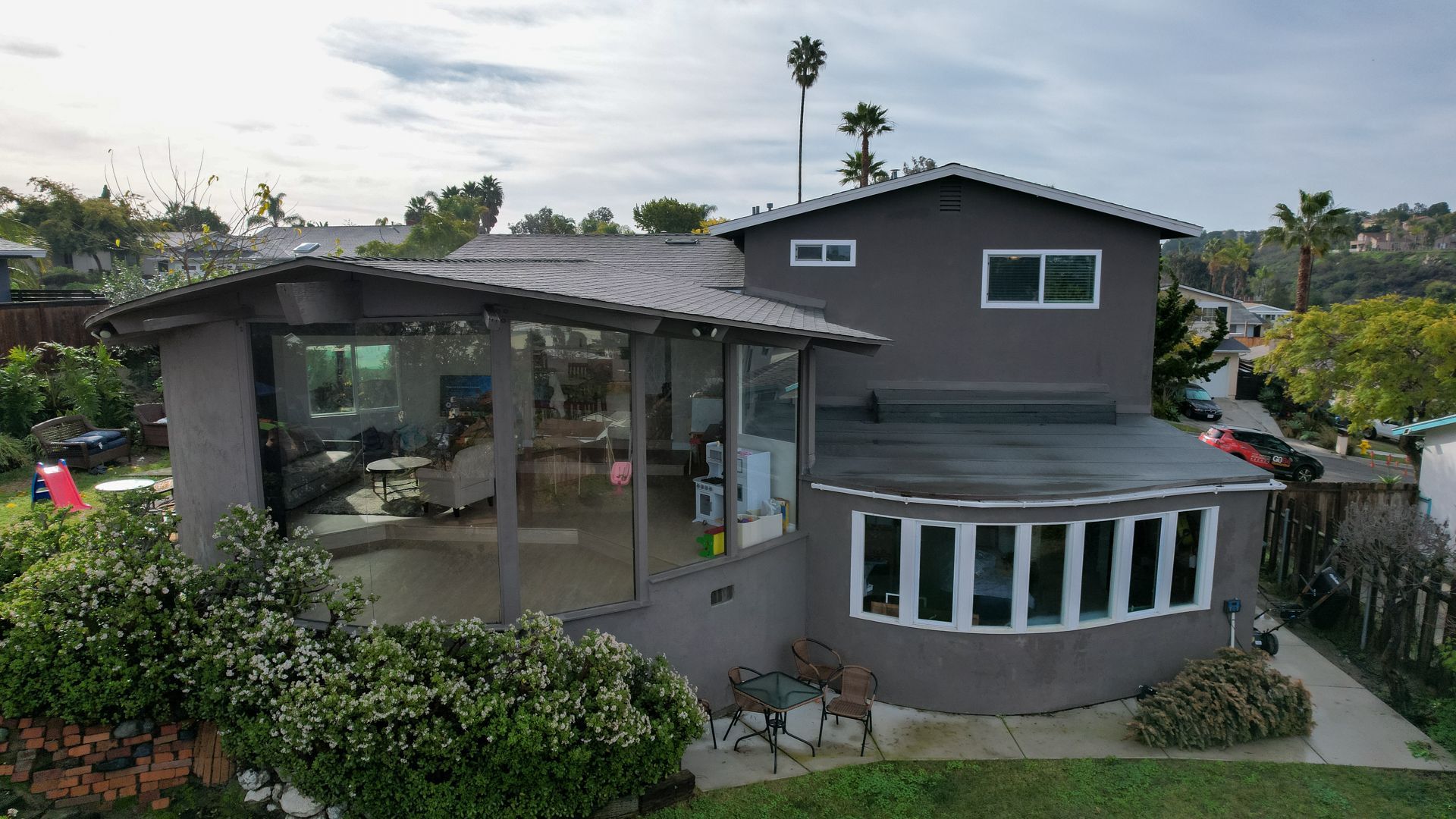 An aerial view of a large house with a lot of windows.