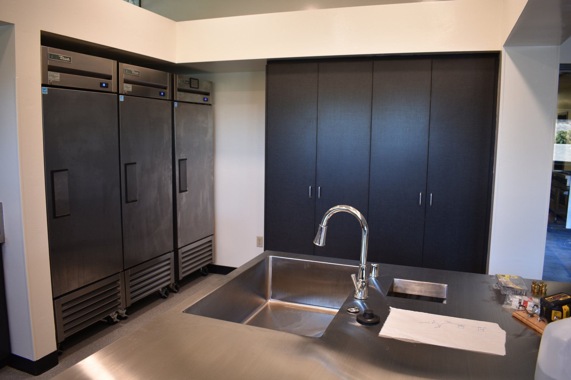 A kitchen with stainless steel appliances and a sink