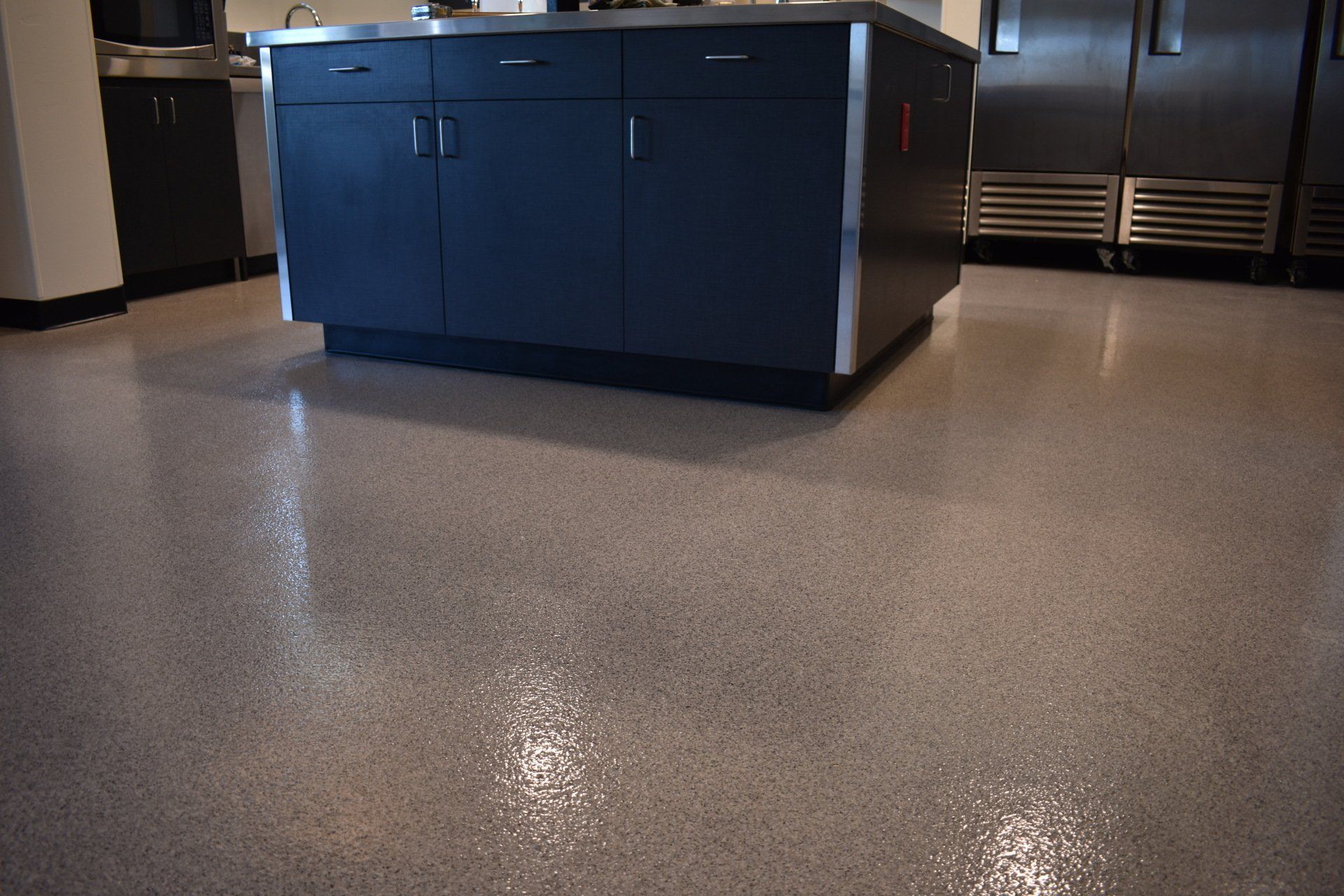 A kitchen with a large island in the middle