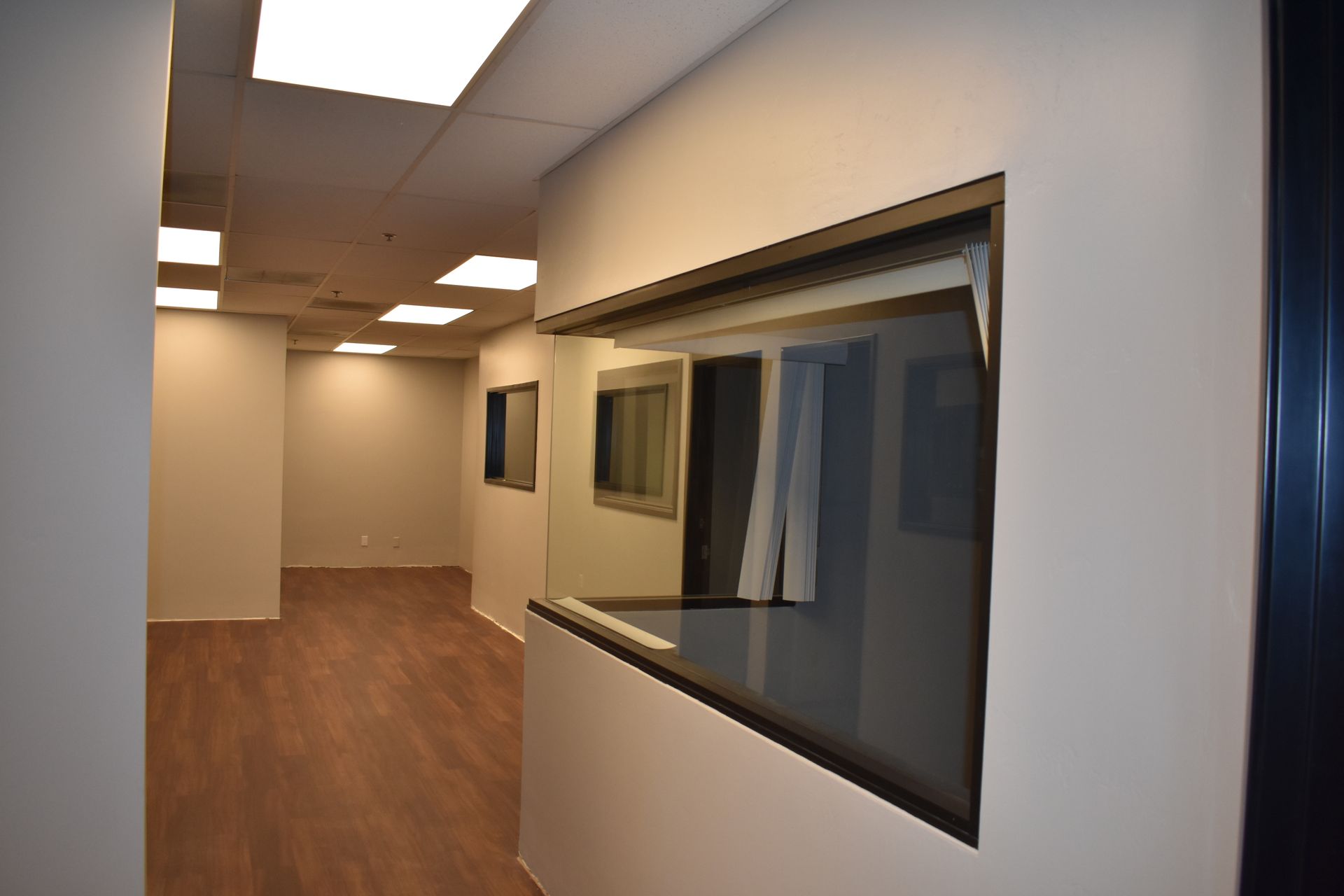 An empty hallway with a window in the wall