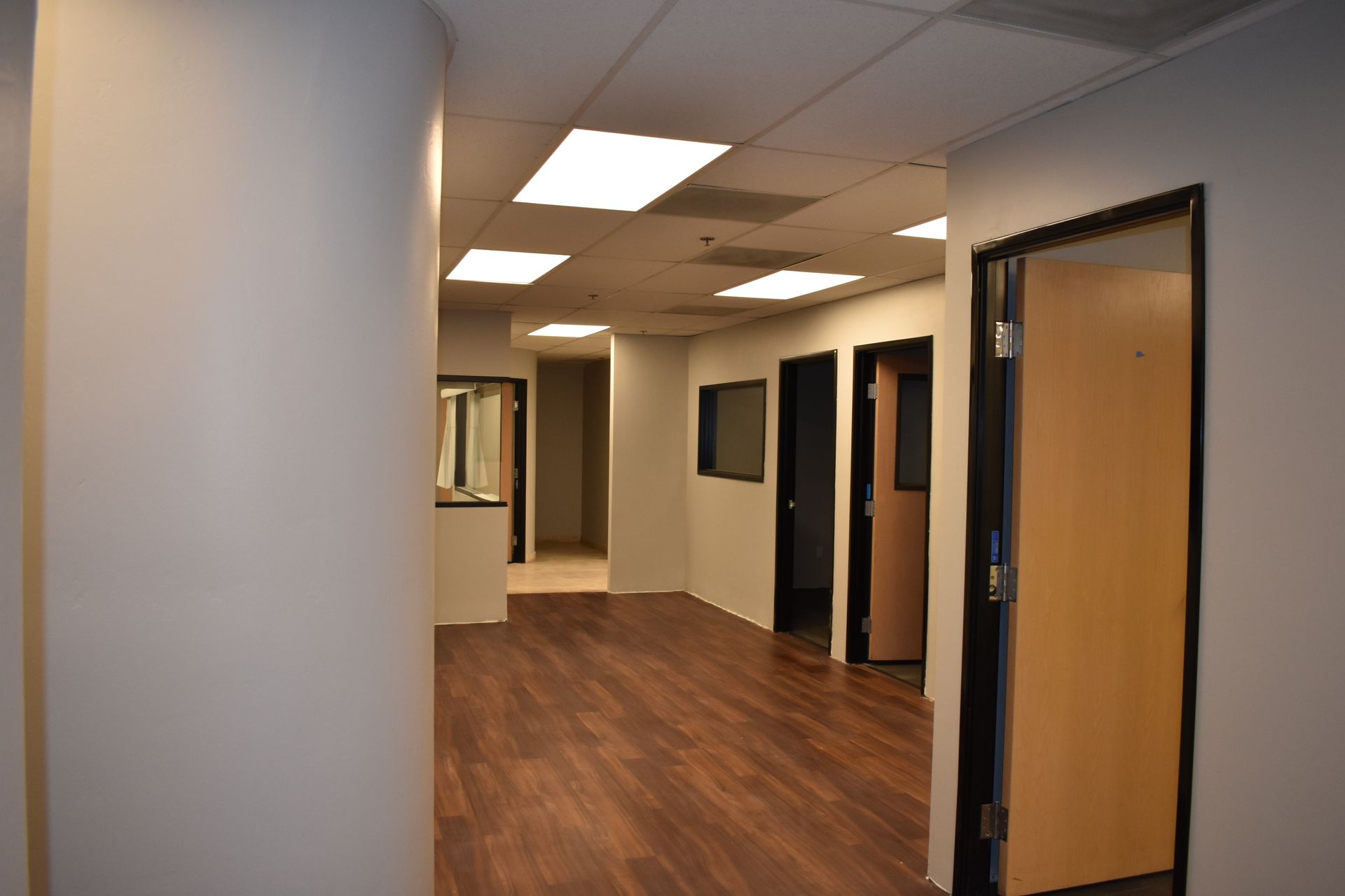 A hallway with wood floors and white walls