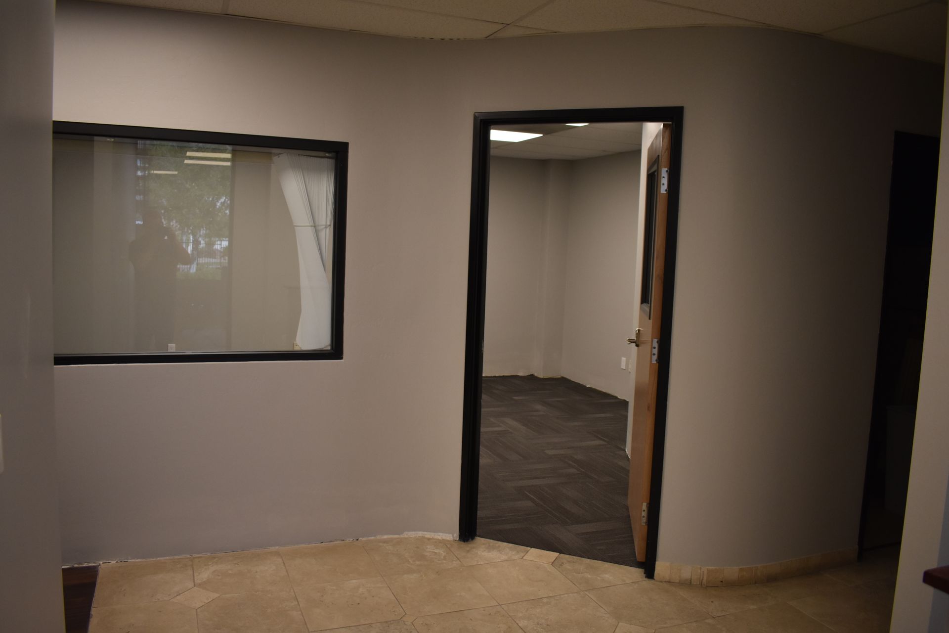 An empty room with a door and a window
