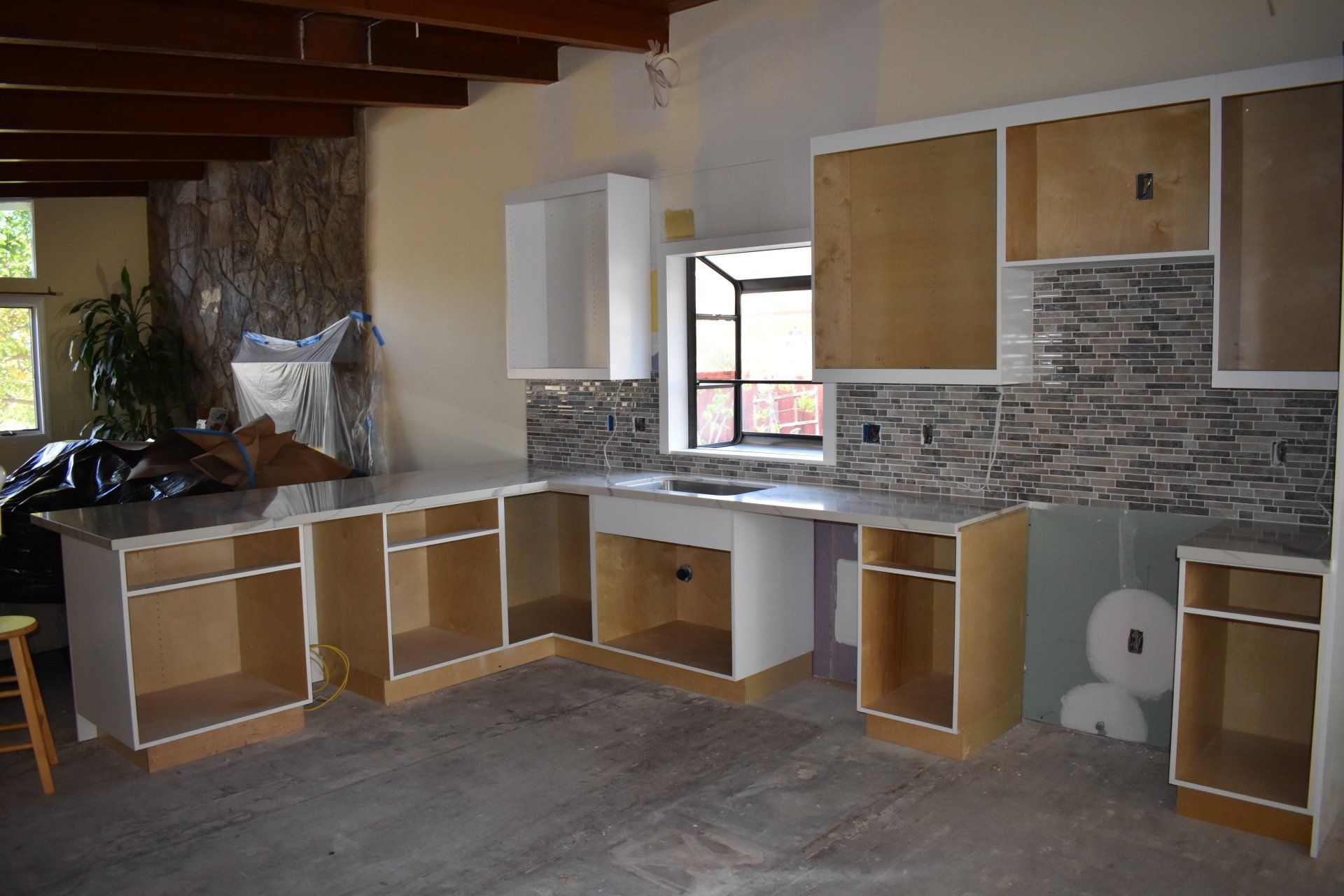 A kitchen with a lot of cabinets and a window