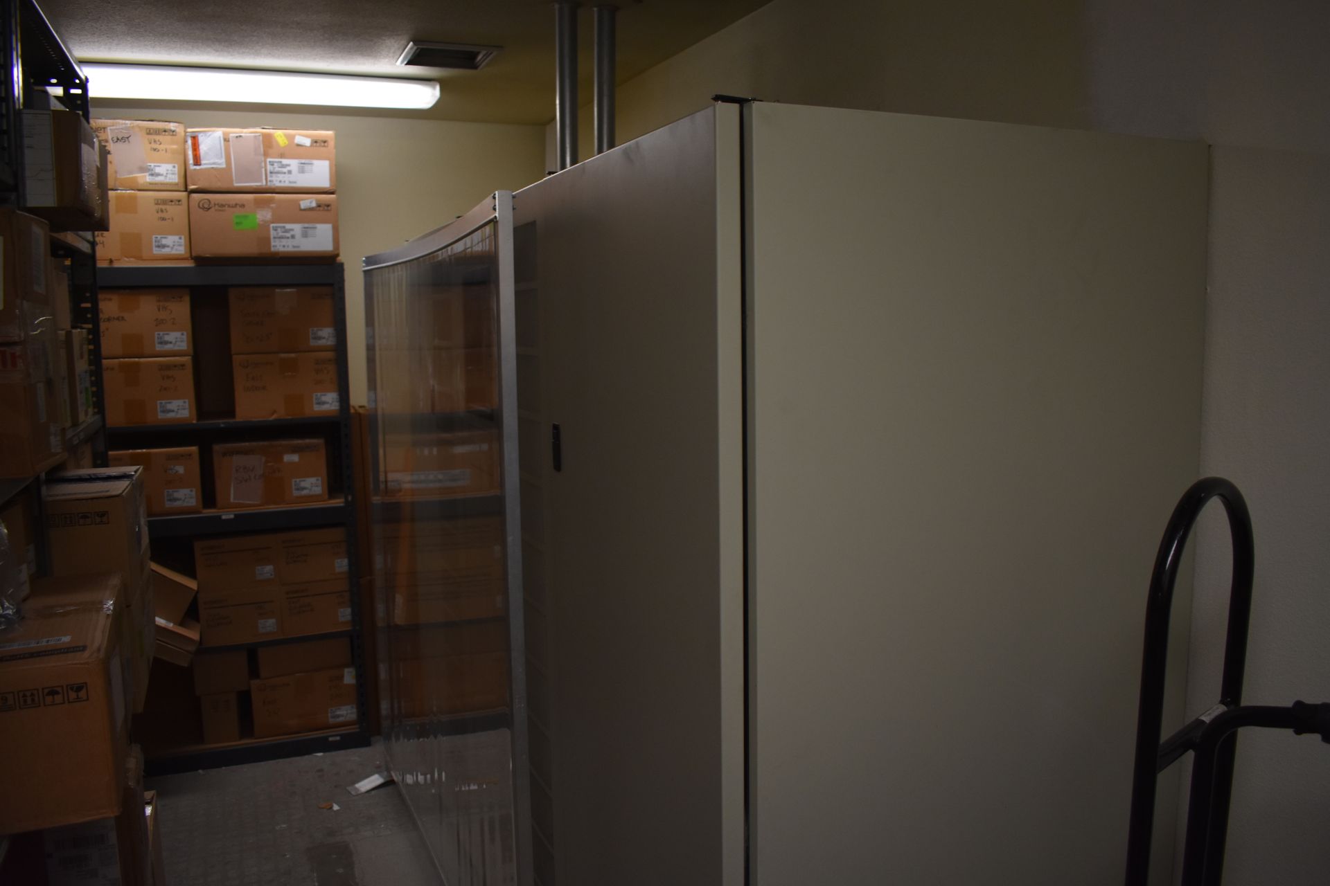 A warehouse filled with lots of boxes and a cart.