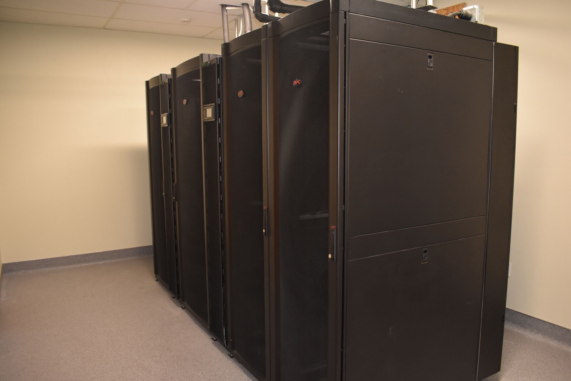 A row of black server racks in a room