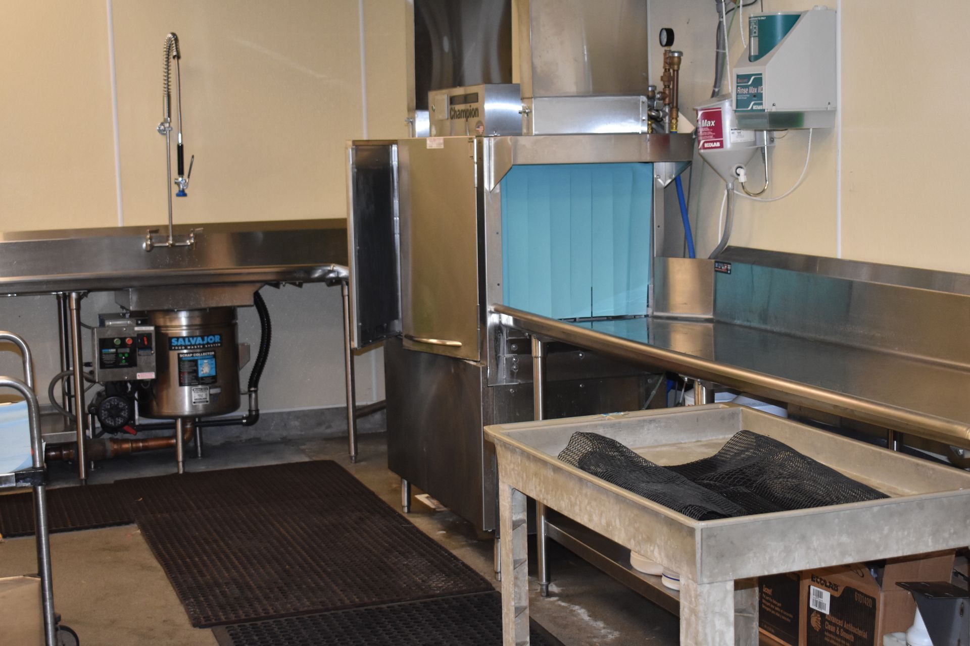 A kitchen with stainless steel counter tops and a dishwasher.