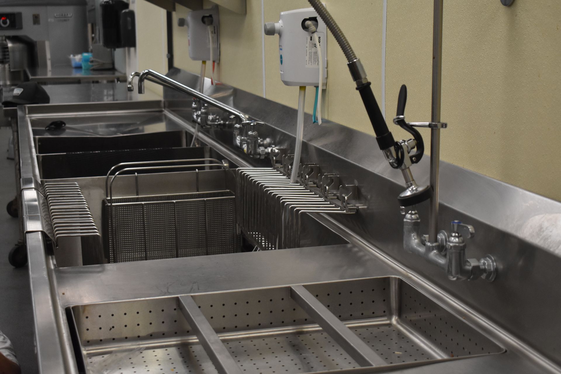 A kitchen with a stainless steel sink and a faucet