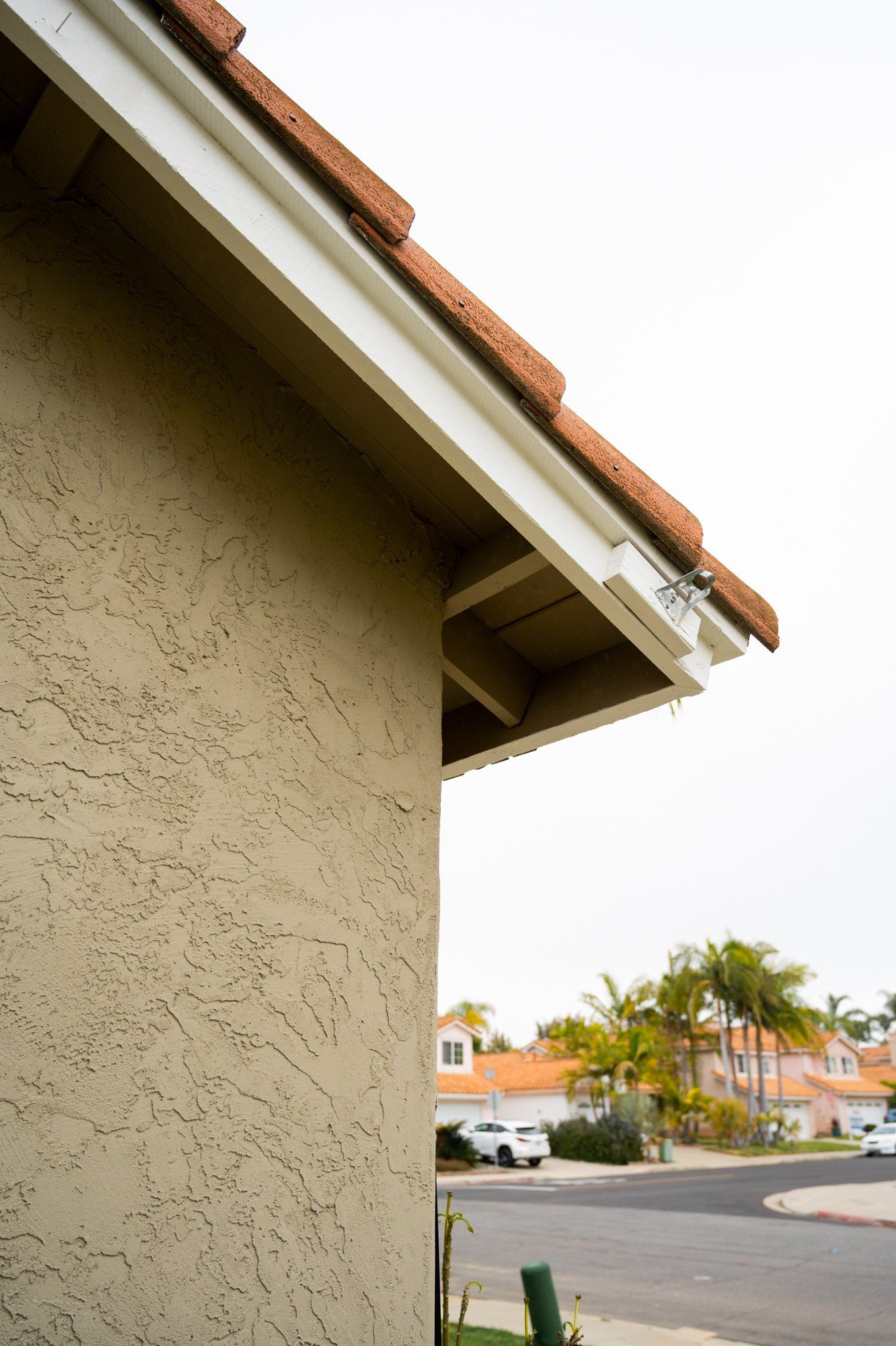 A side view of a house with a white trim on the roof
