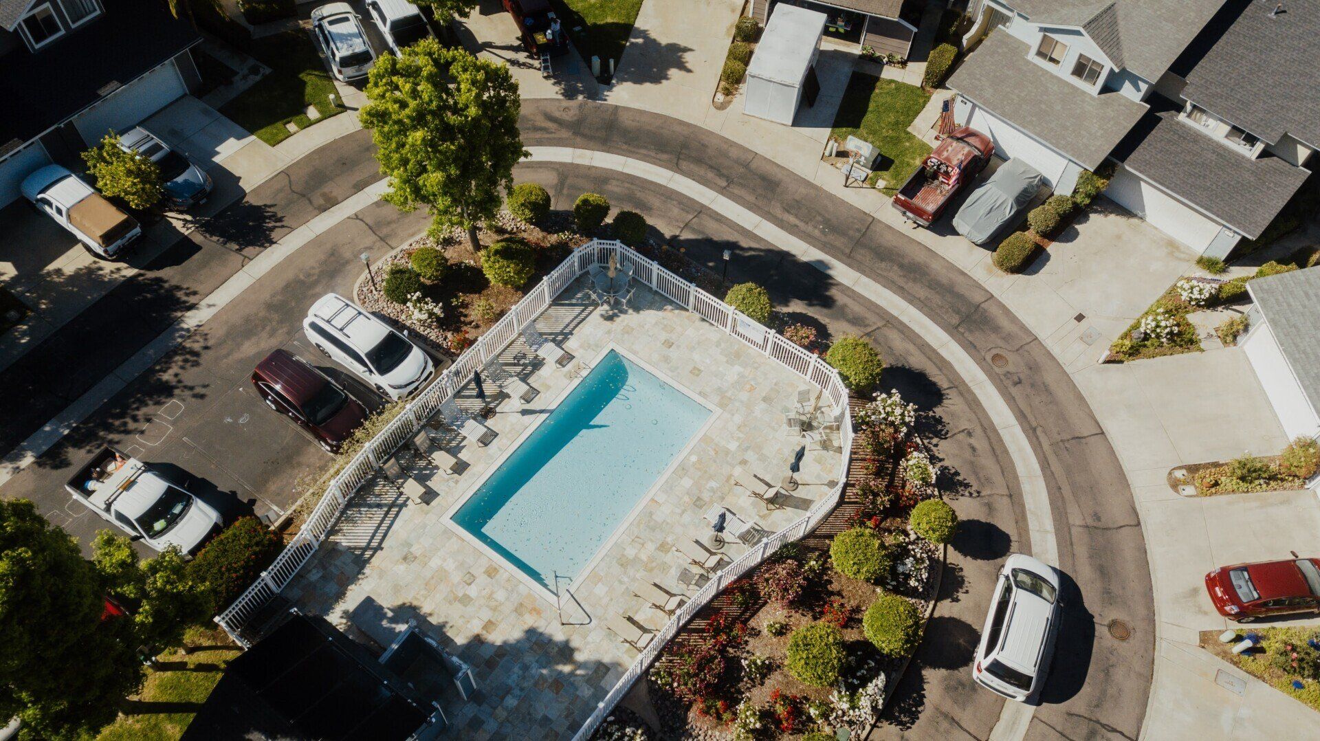 An aerial view of a residential area with a swimming pool