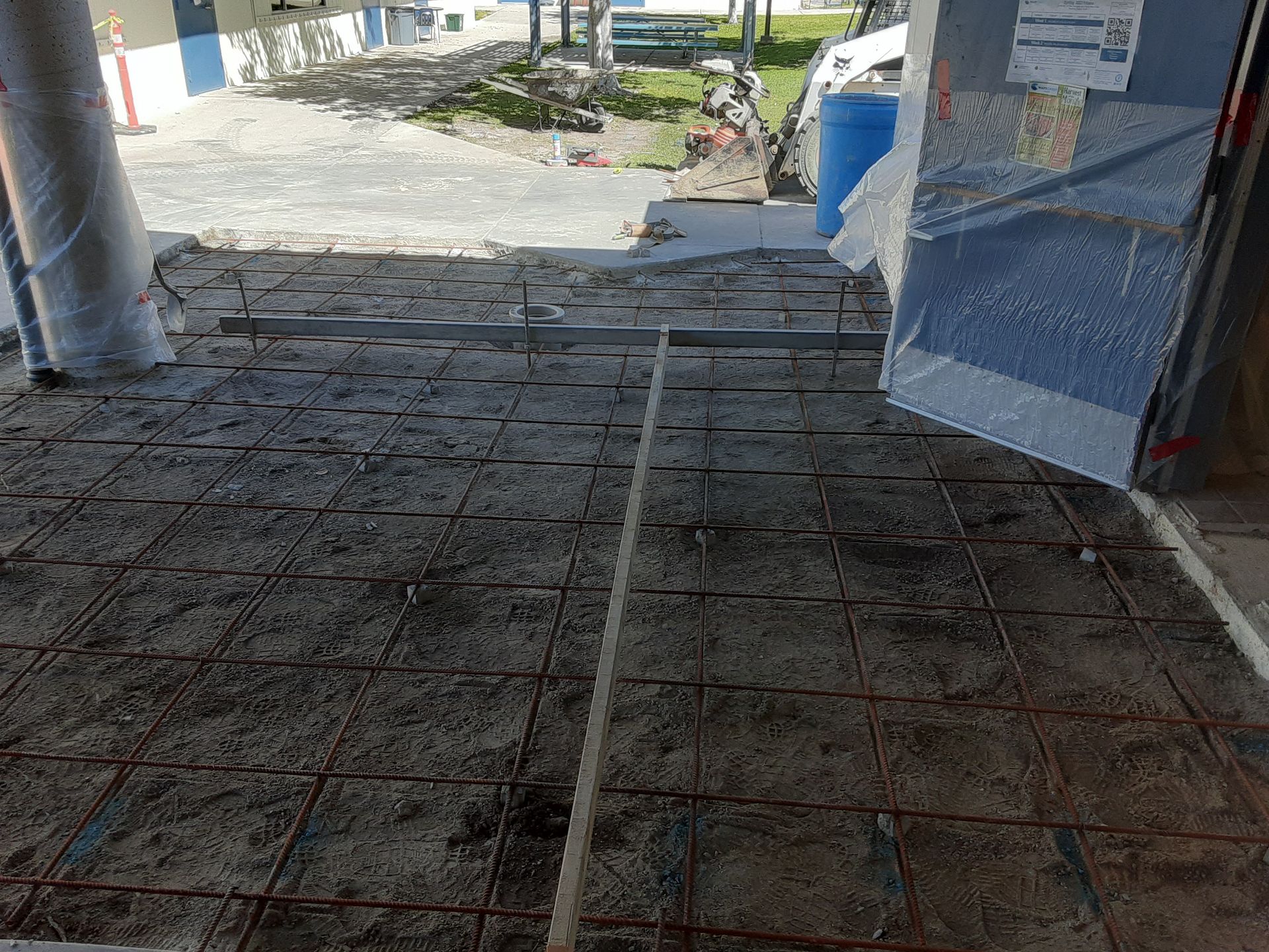 A concrete floor is being built in a garage.