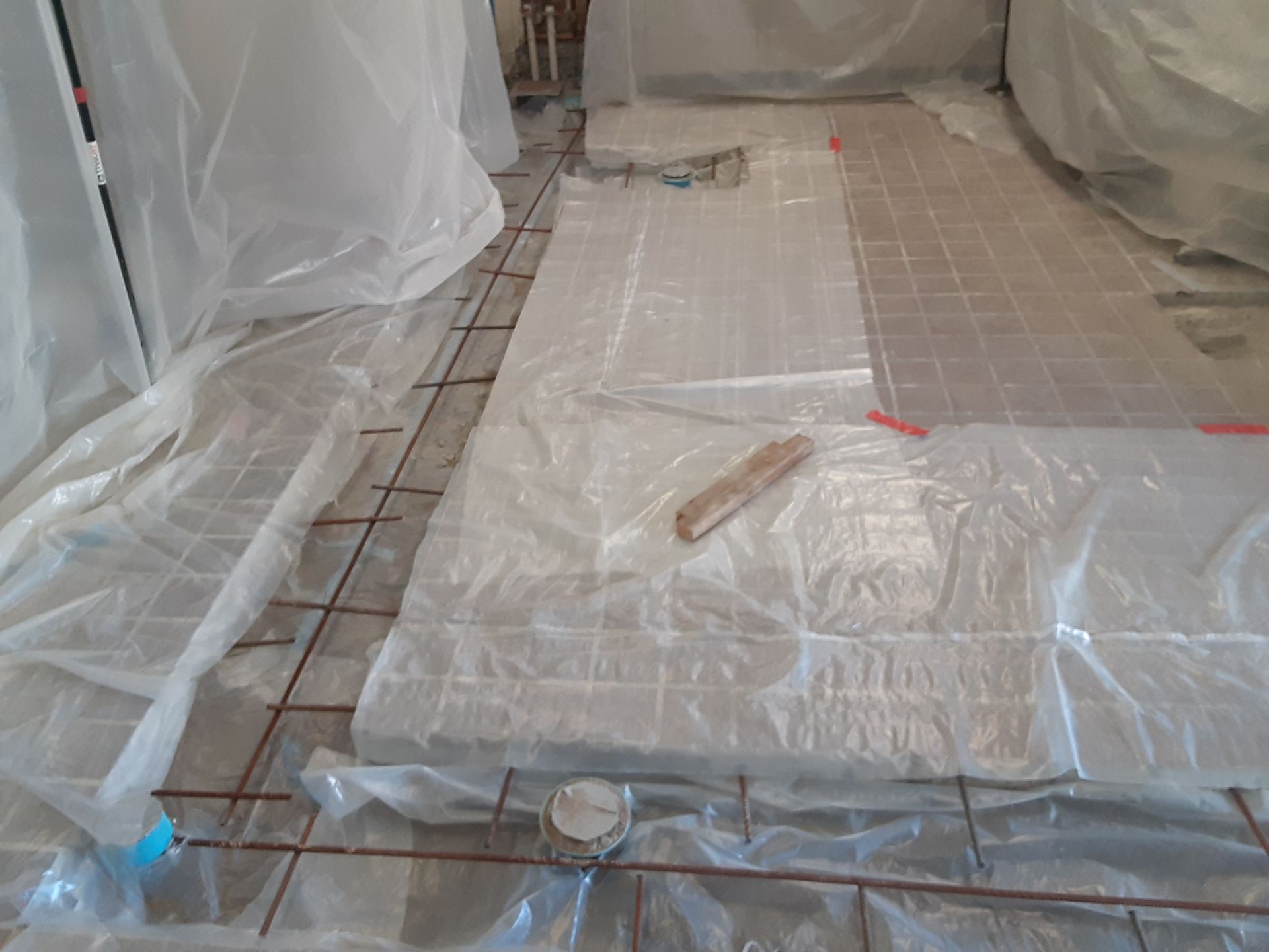 A room with a lot of plastic covering the floor.