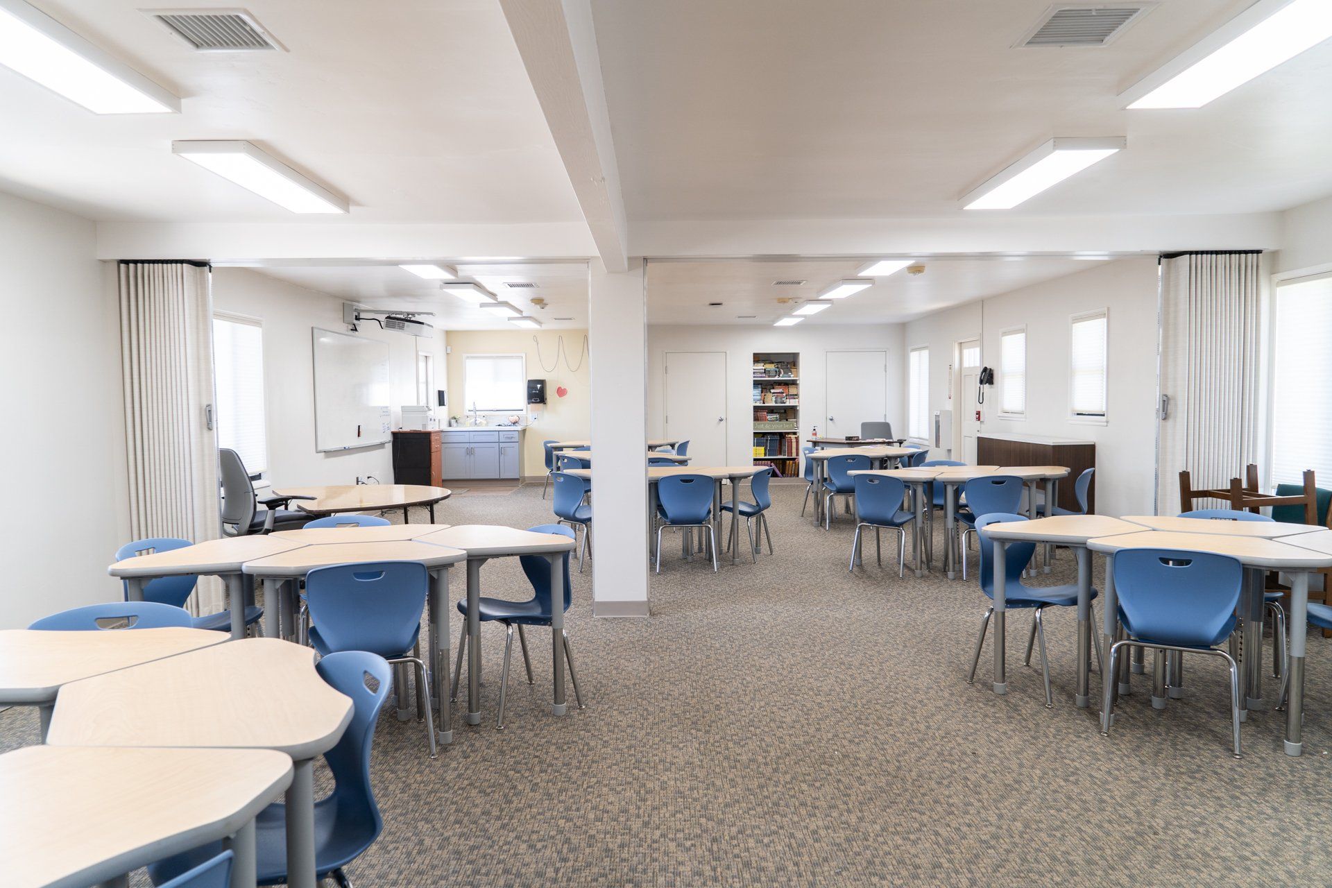 A large room with tables and chairs in it.