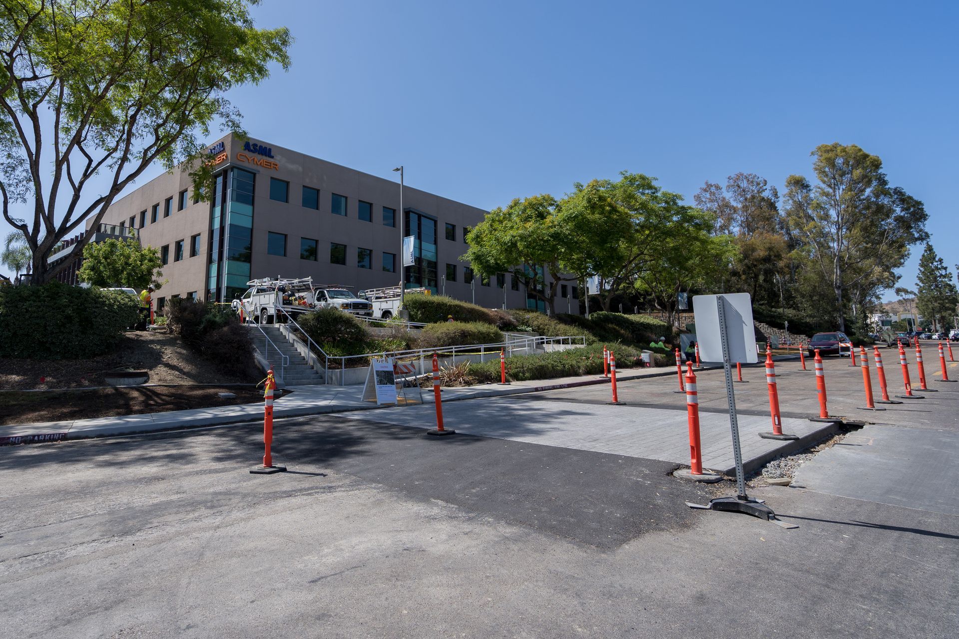 A large building with a lot of orange cones in front of it