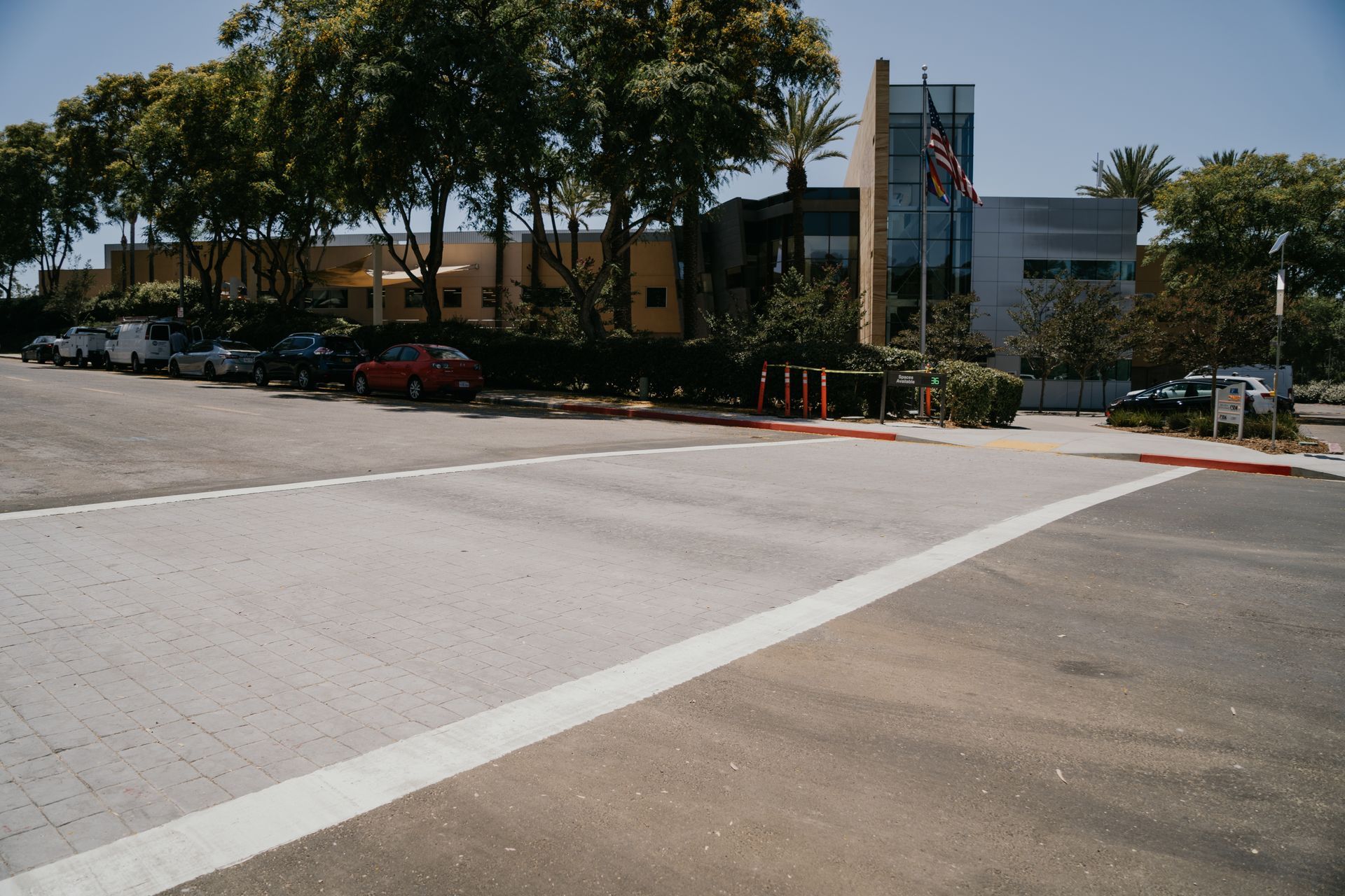 A parking lot with cars parked in front of a building