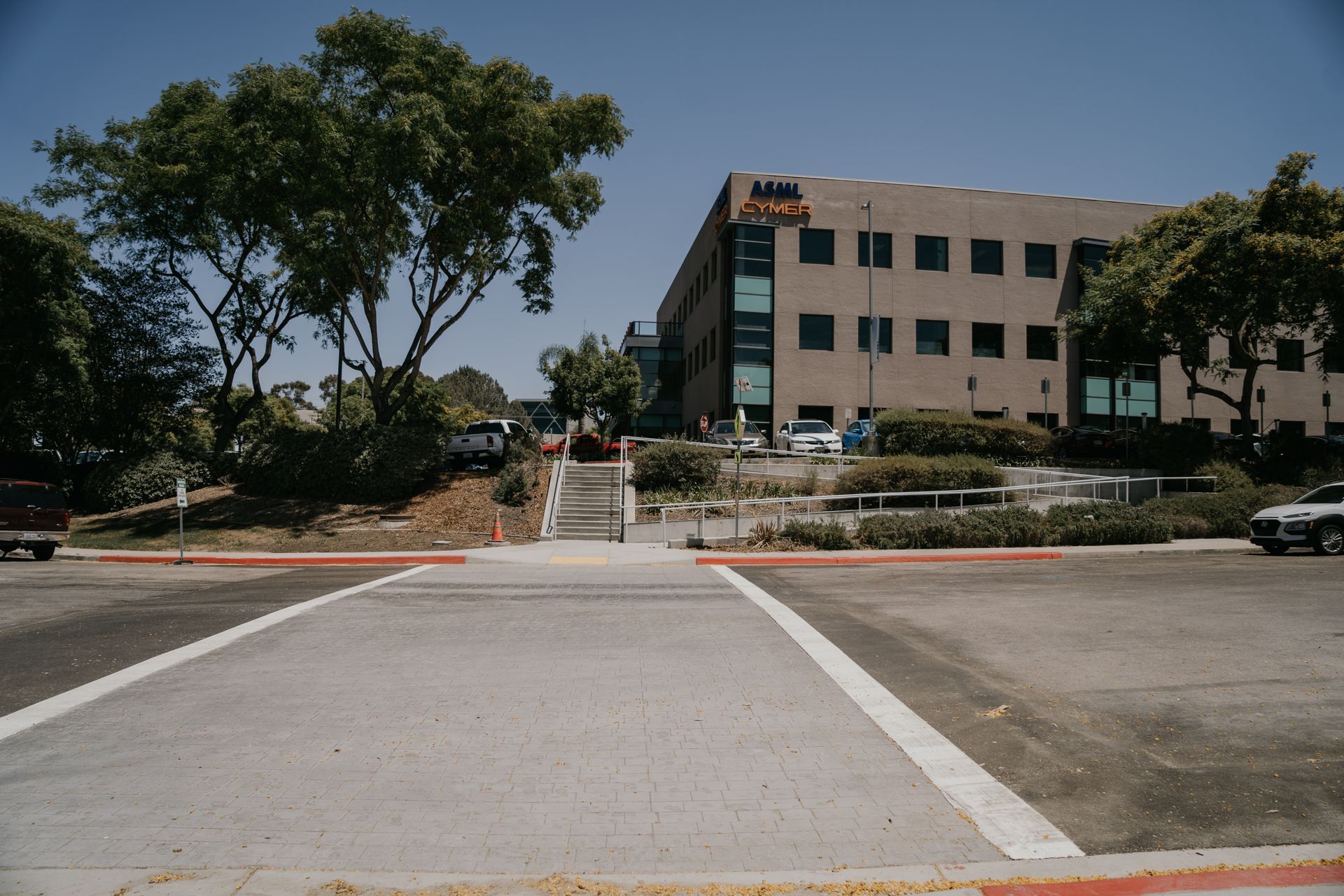 A parking lot with a large building in the background