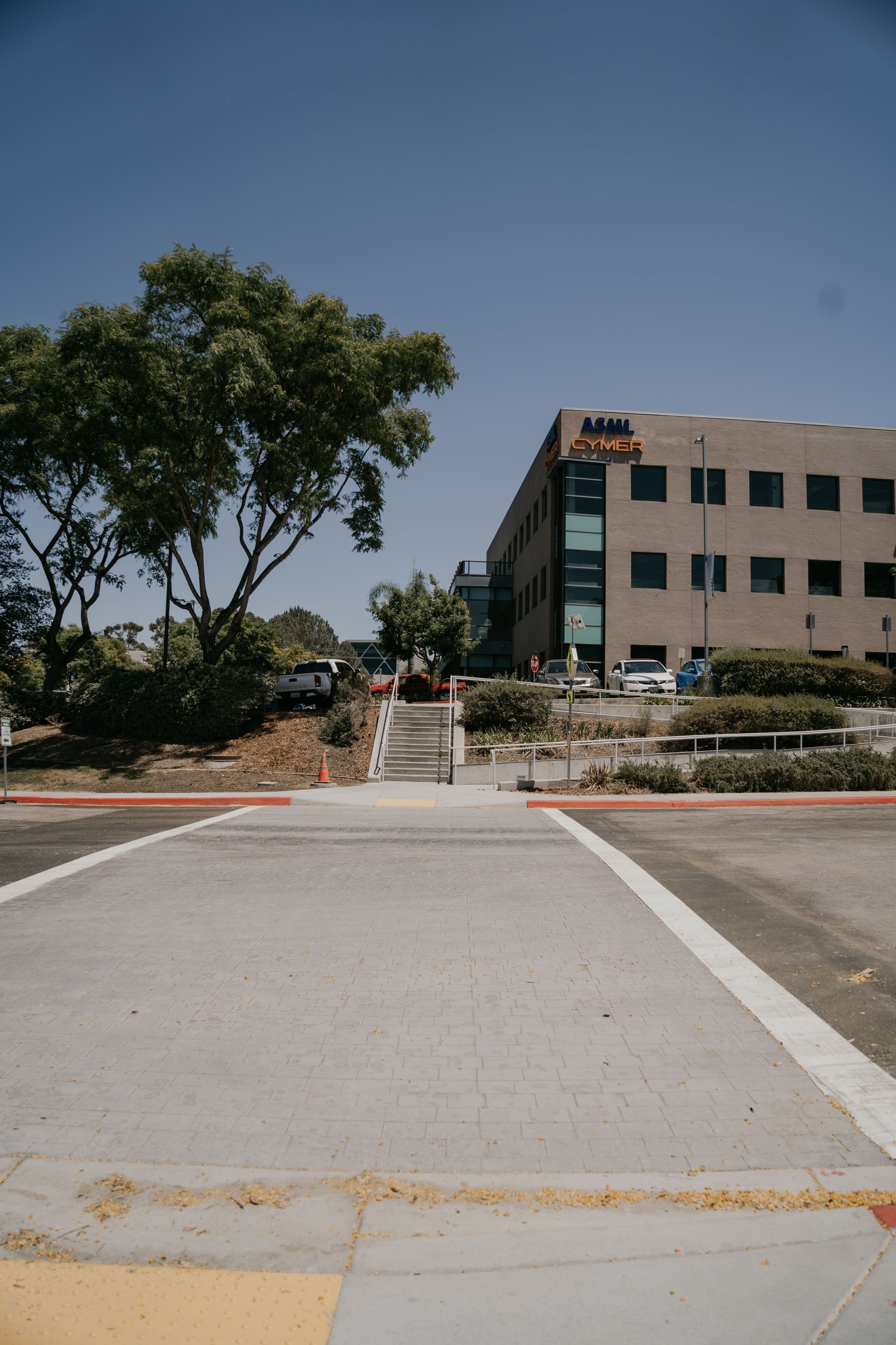 A parking lot with a large building in the background.