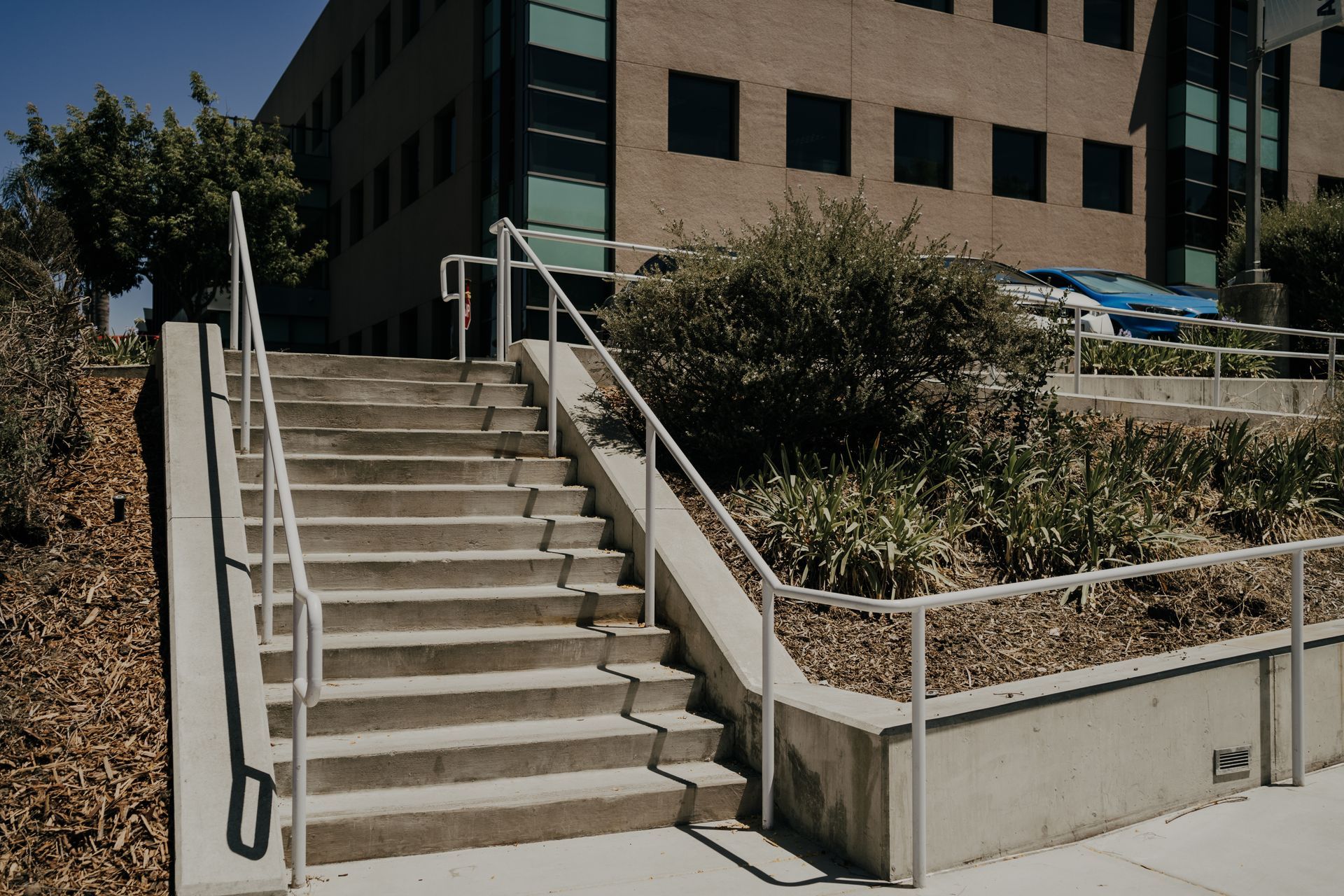 A set of stairs leading up to a building with a railing