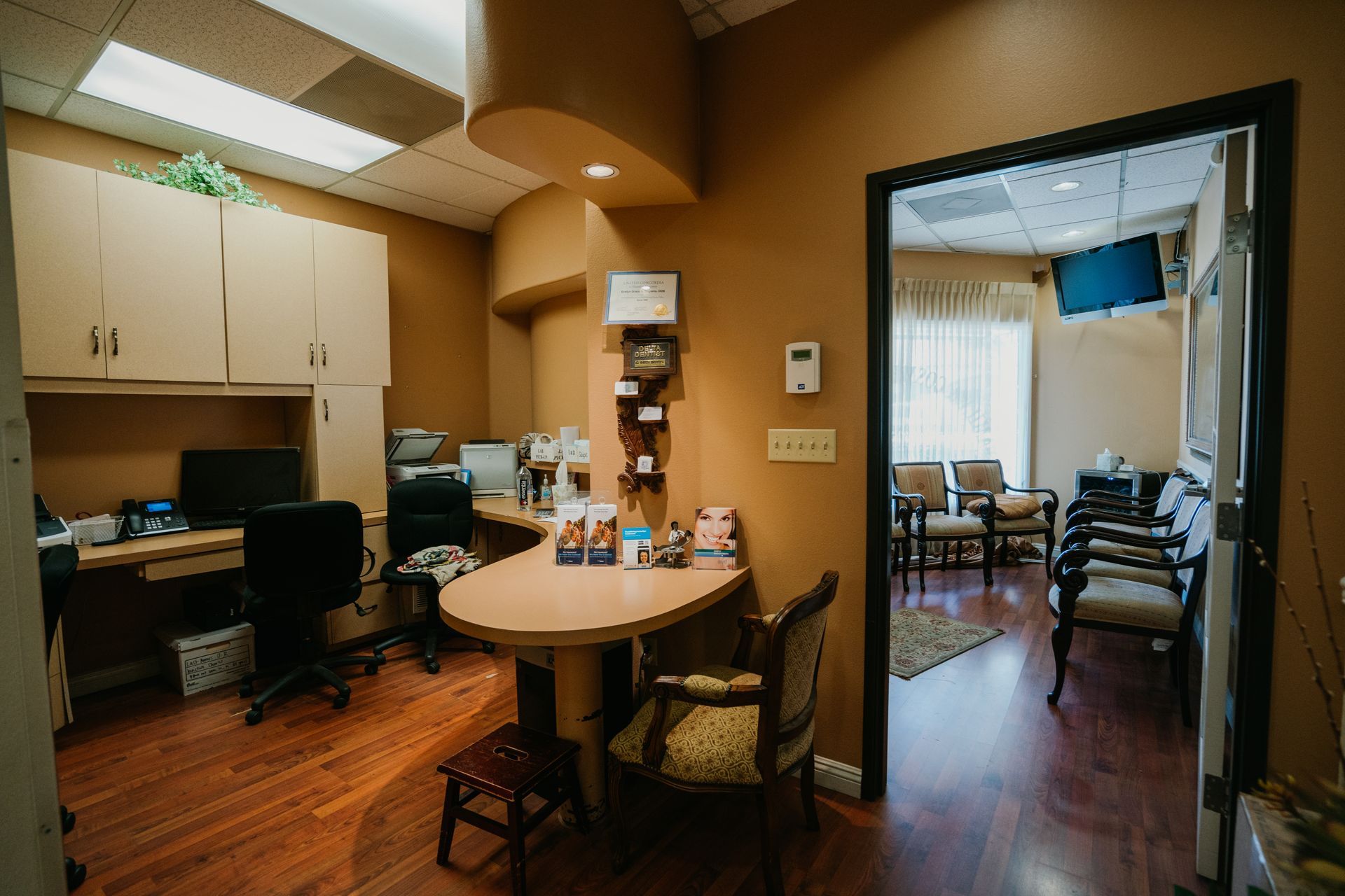 A dental office with a table and chairs in it.