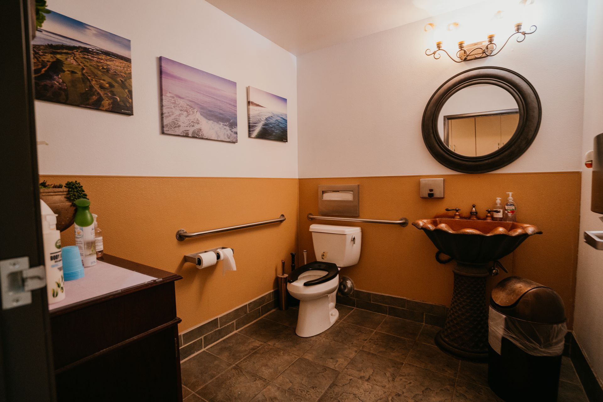 A bathroom with a toilet , sink and mirror.