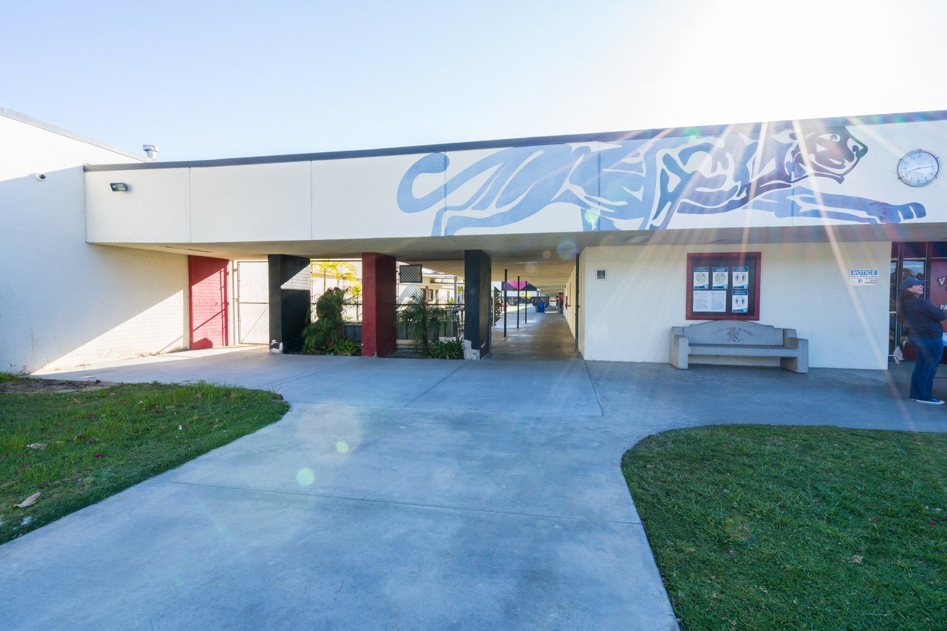 A large white building with a mural on the side of it.
