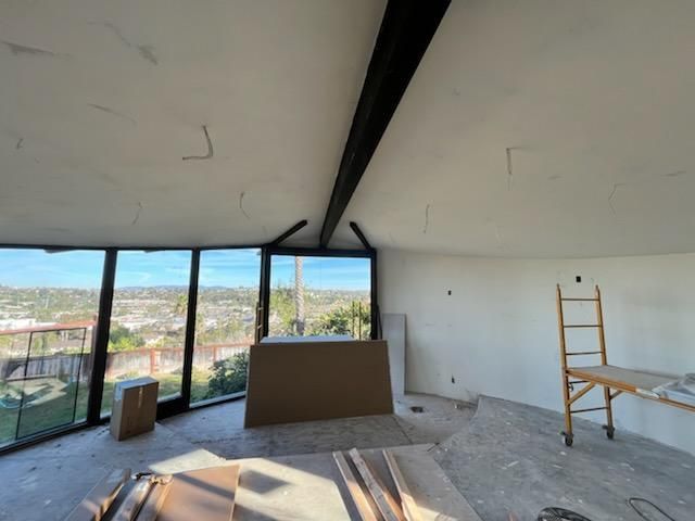 A room with a lot of windows and a ladder
