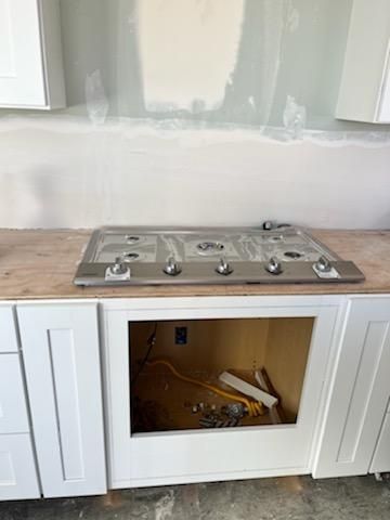 A stove top oven is being installed in a kitchen.