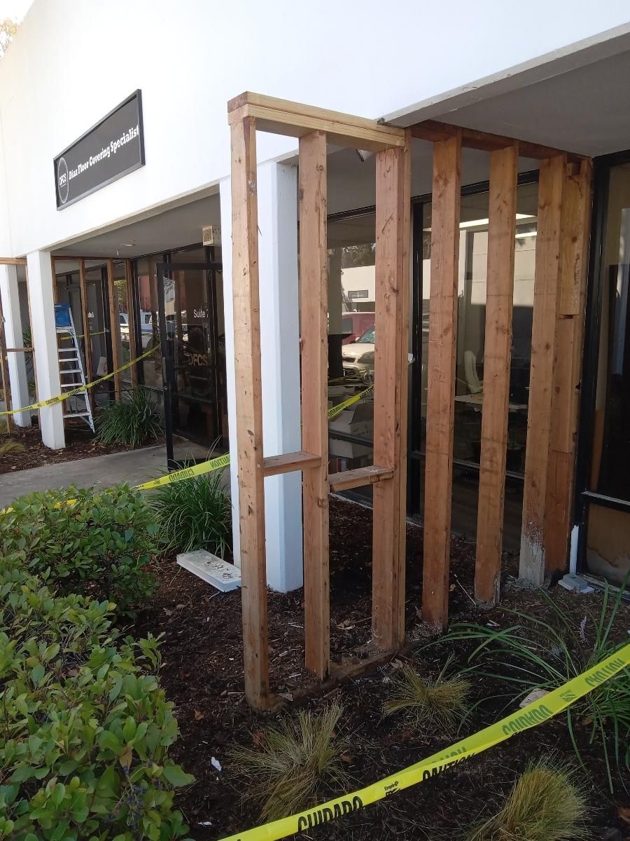 A building is being remodeled with wooden beams.