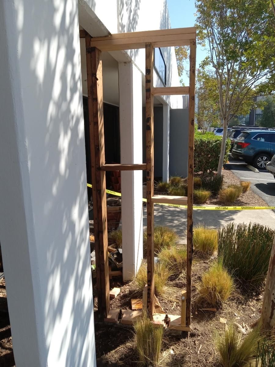A wooden frame is being built on the side of a building