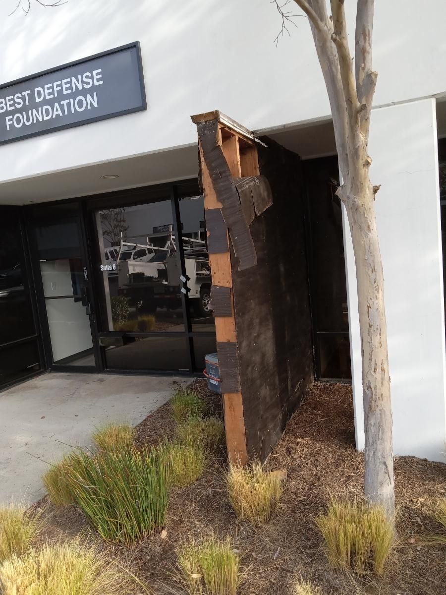 A building with a sign that says best defense foundation