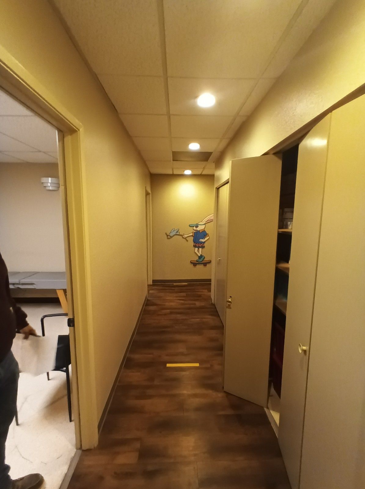 A long hallway with a cartoon character on the wall.