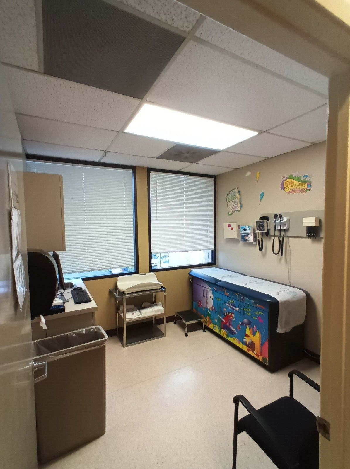 A doctor 's office with a bed and a chair