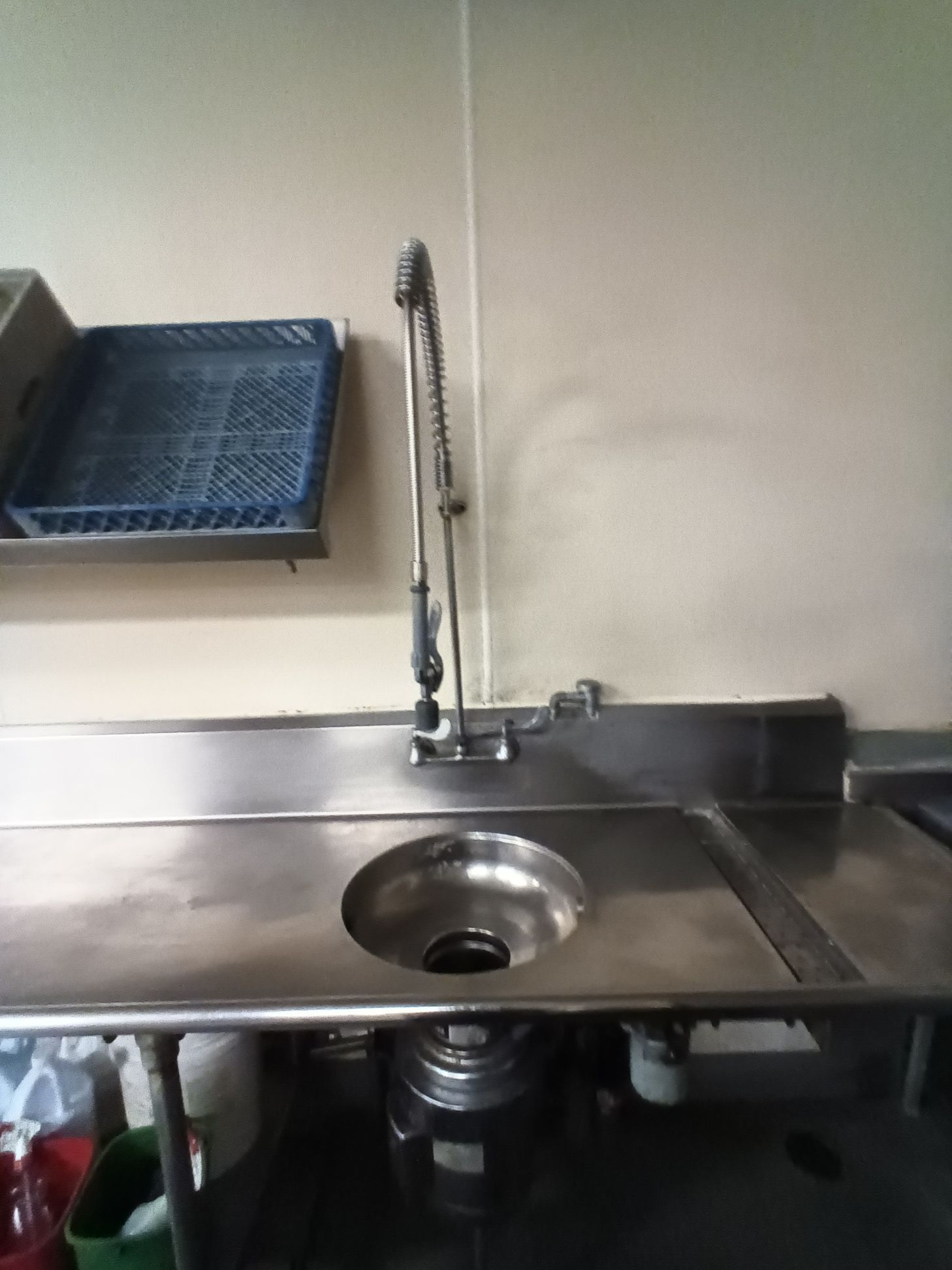 A stainless steel counter top with a sink underneath it