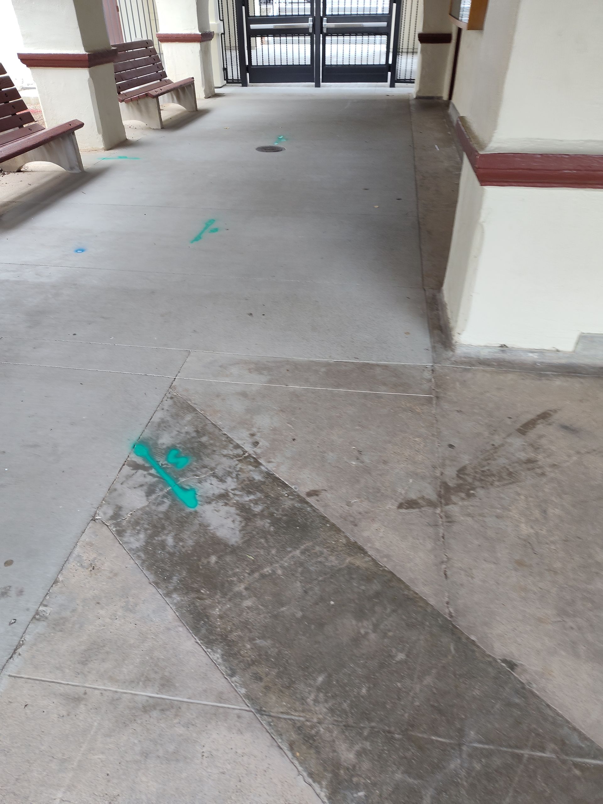A concrete floor with a green arrow on it
