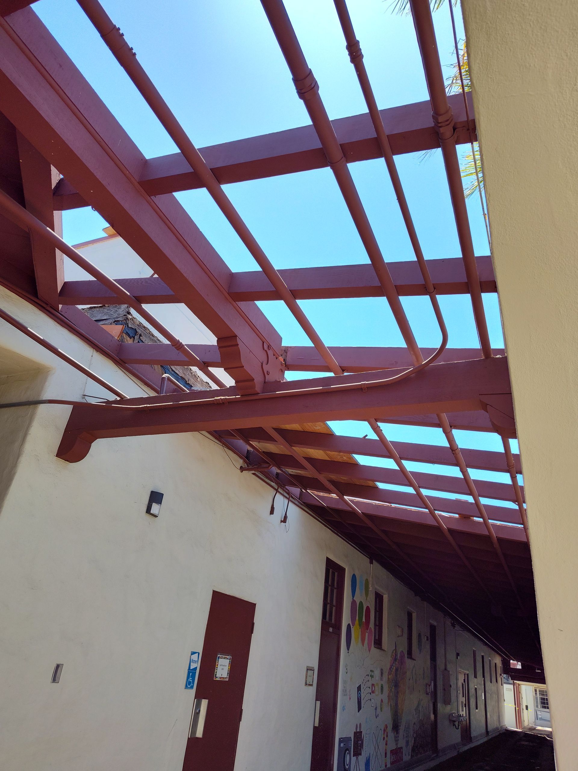 A building with a red roof and a blue sky