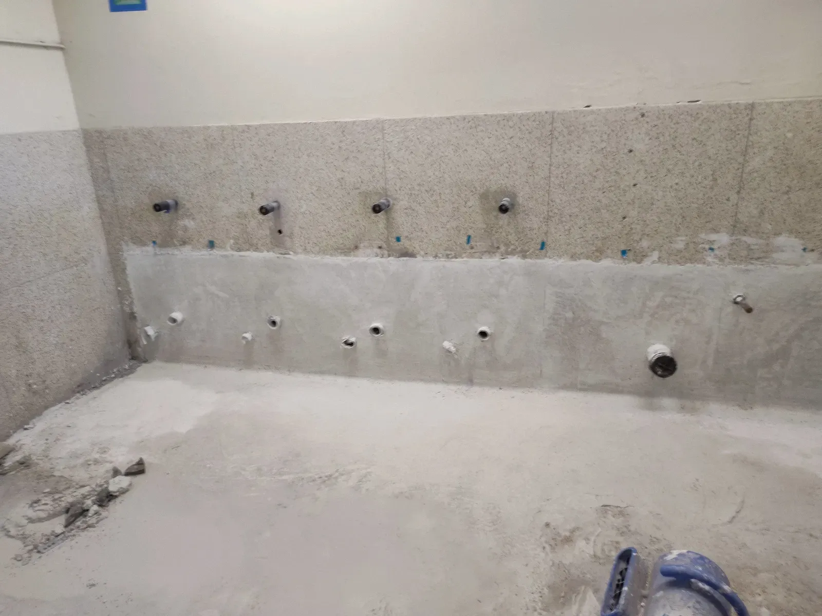 A bathroom under construction with a lot of holes in the wall.