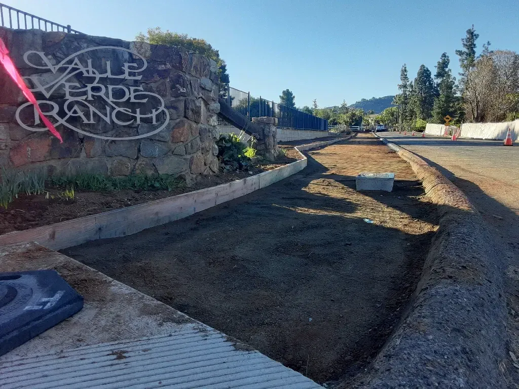 A sign for valle verde ranch is on the side of a road