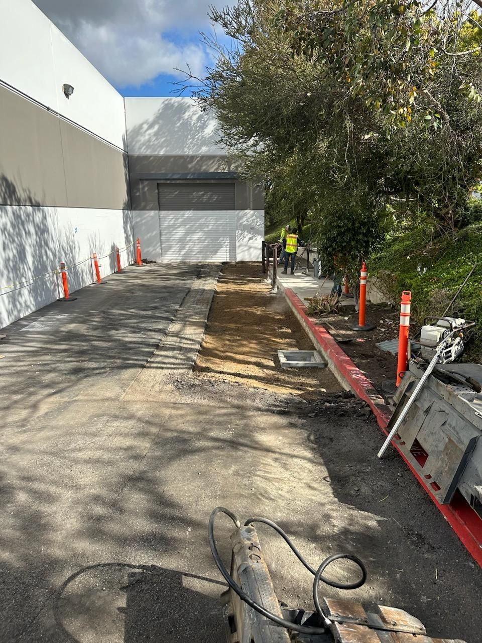 A concrete driveway is being built in front of a building.