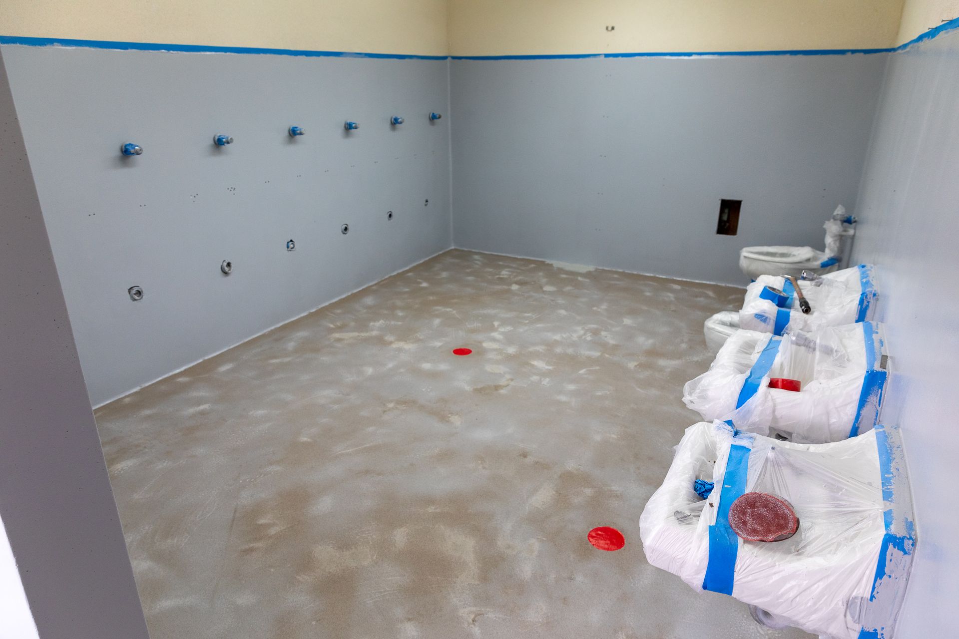 A bathroom with a row of sinks in it