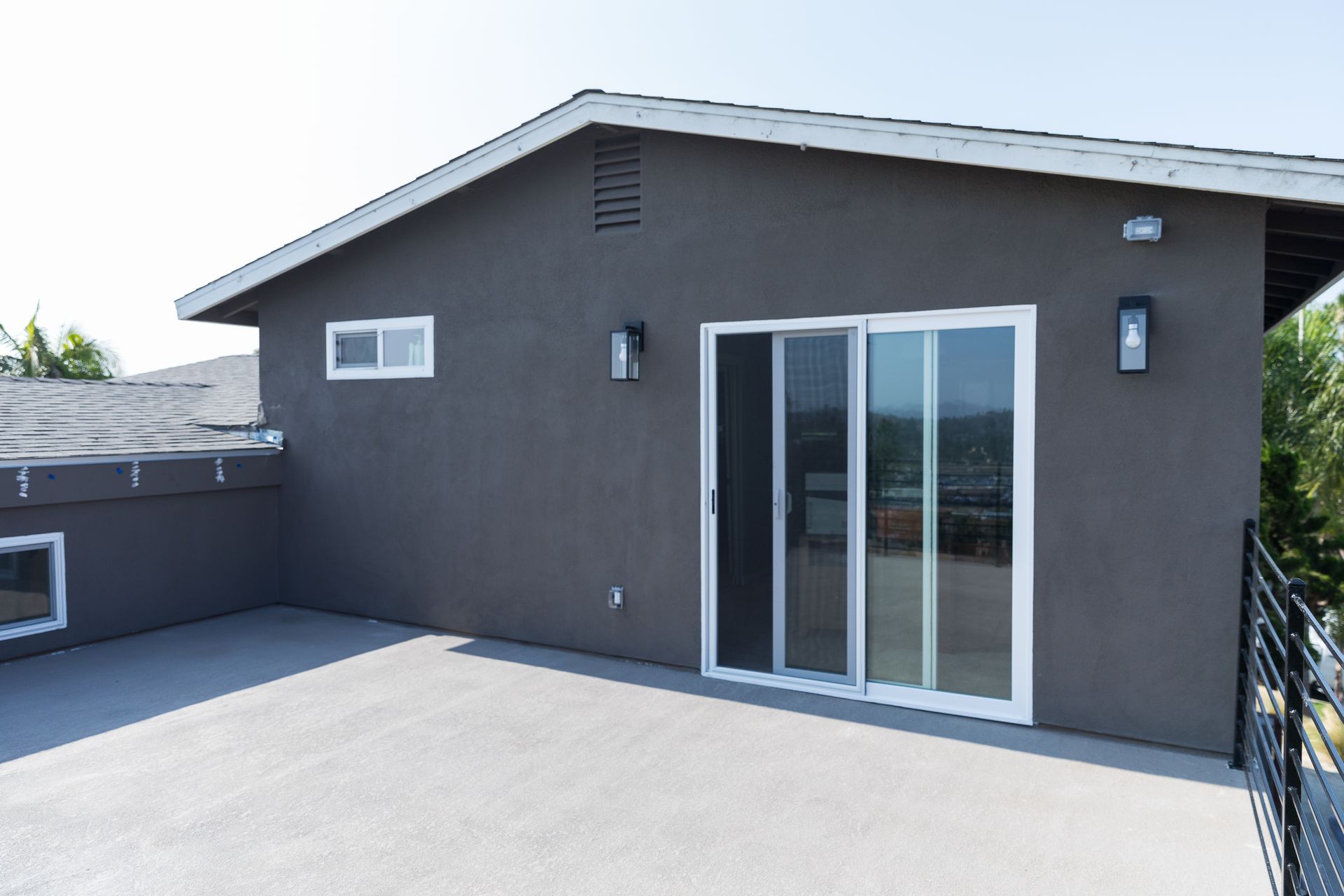 A house with a balcony and sliding glass doors