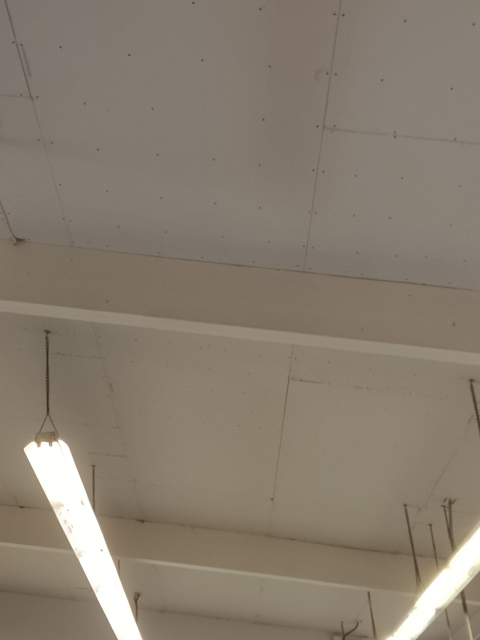 A ceiling with a few lights hanging from it